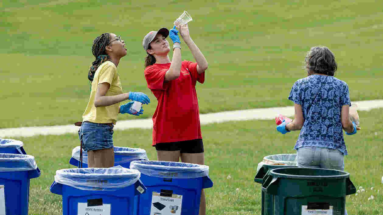 two students examine trash