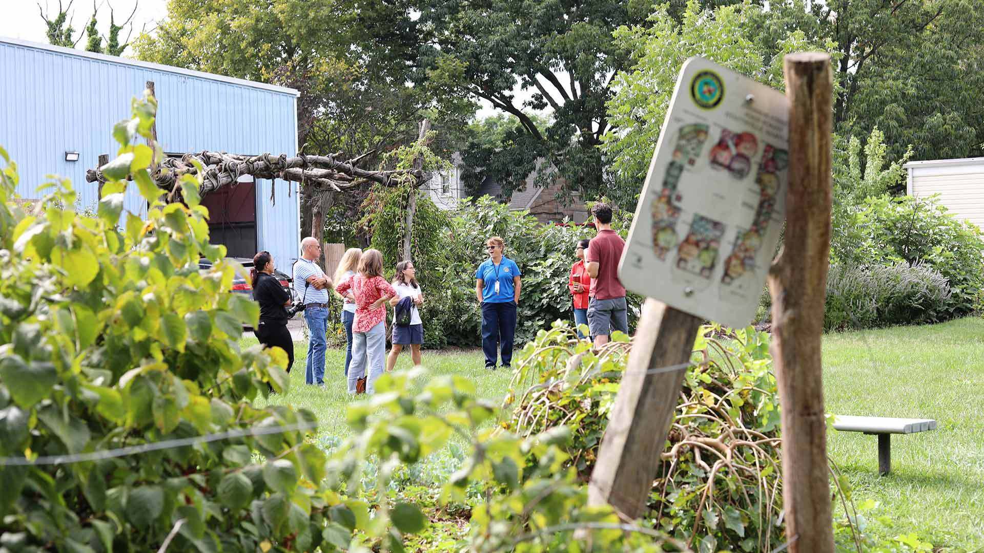 group gathers in food forest