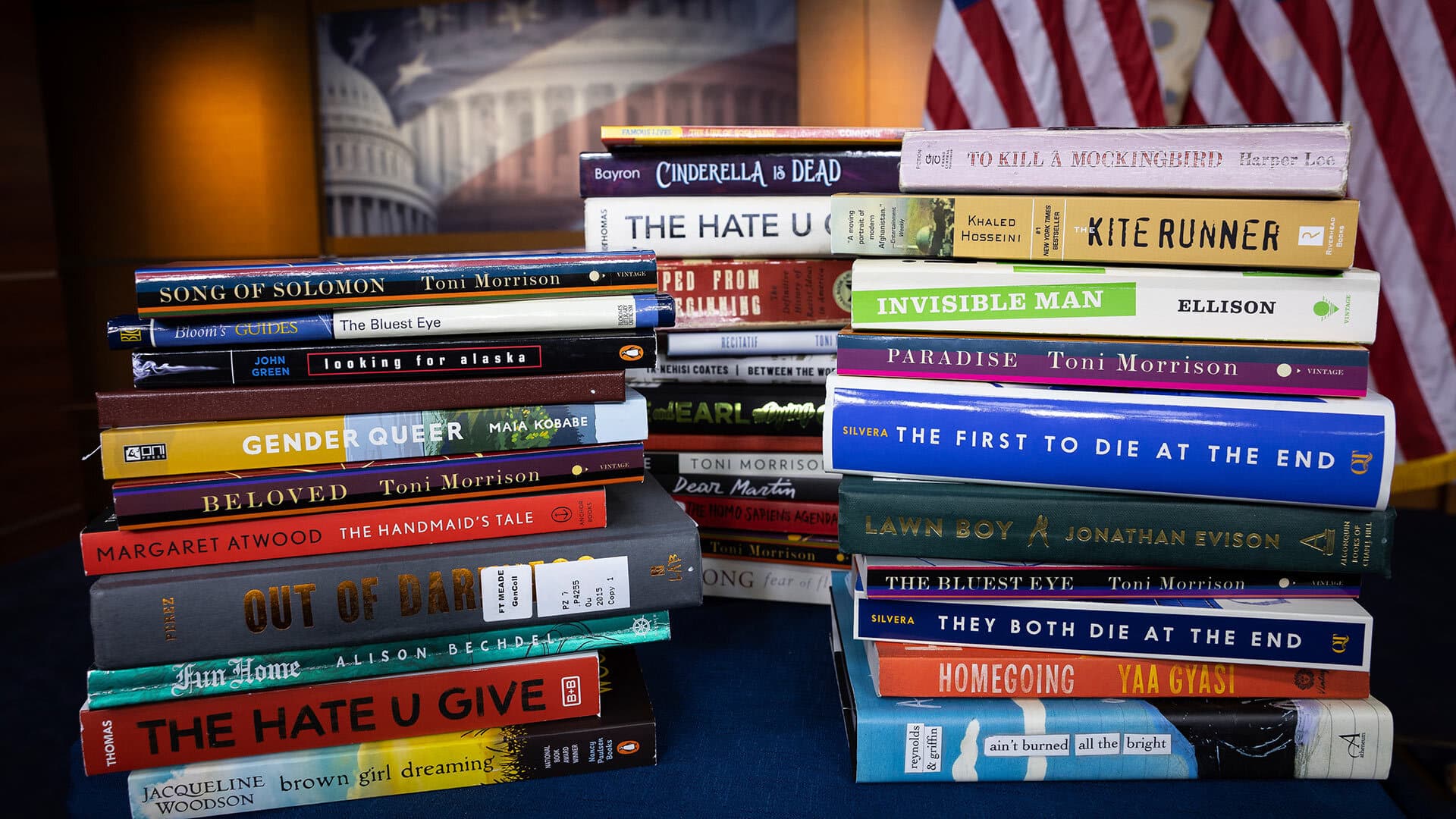 Stacks of books with American flags in the background