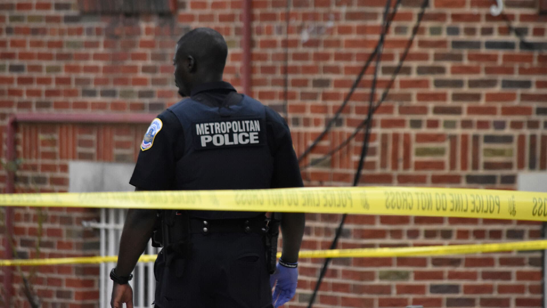 metropolitan police officer stands at Washington DC crime scene