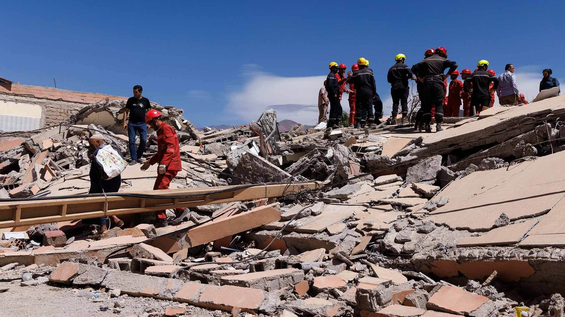 rescuers climb on an earthquake collapsed building