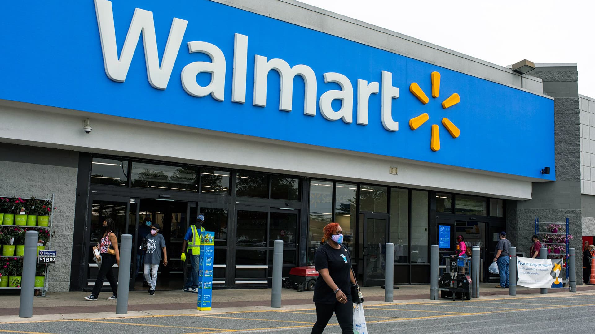 Shoppers walk out of a Walmart store