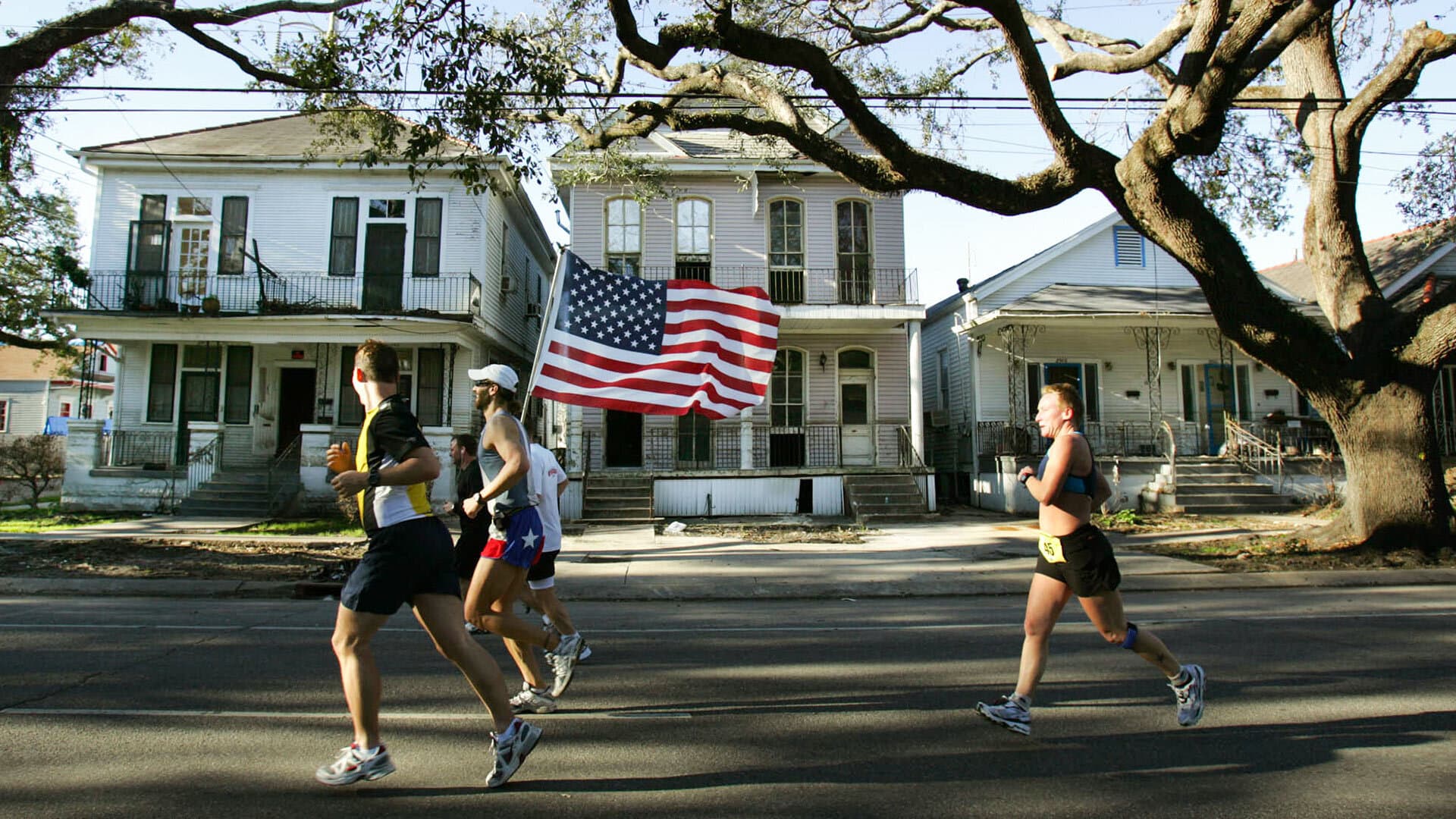 Runners run with an American flag