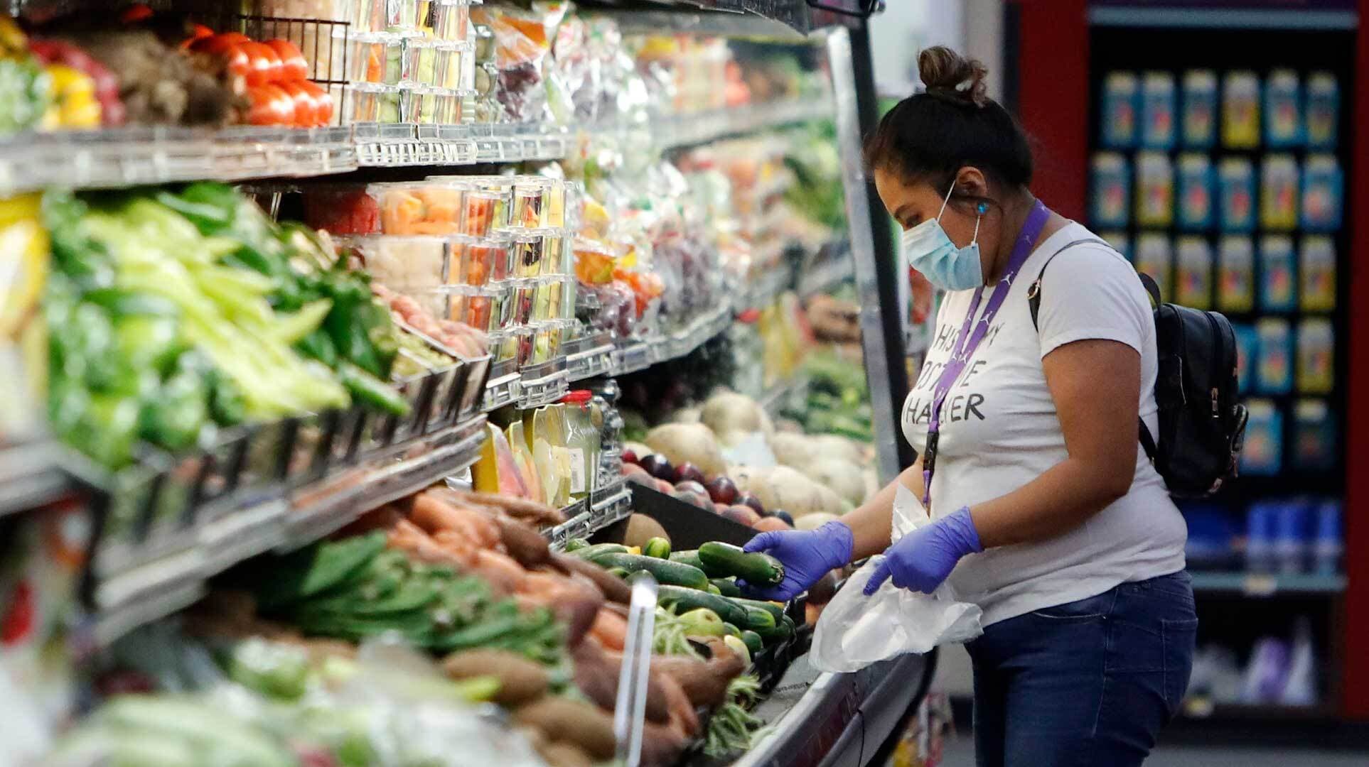 Woman wears surgical mask at grocery store