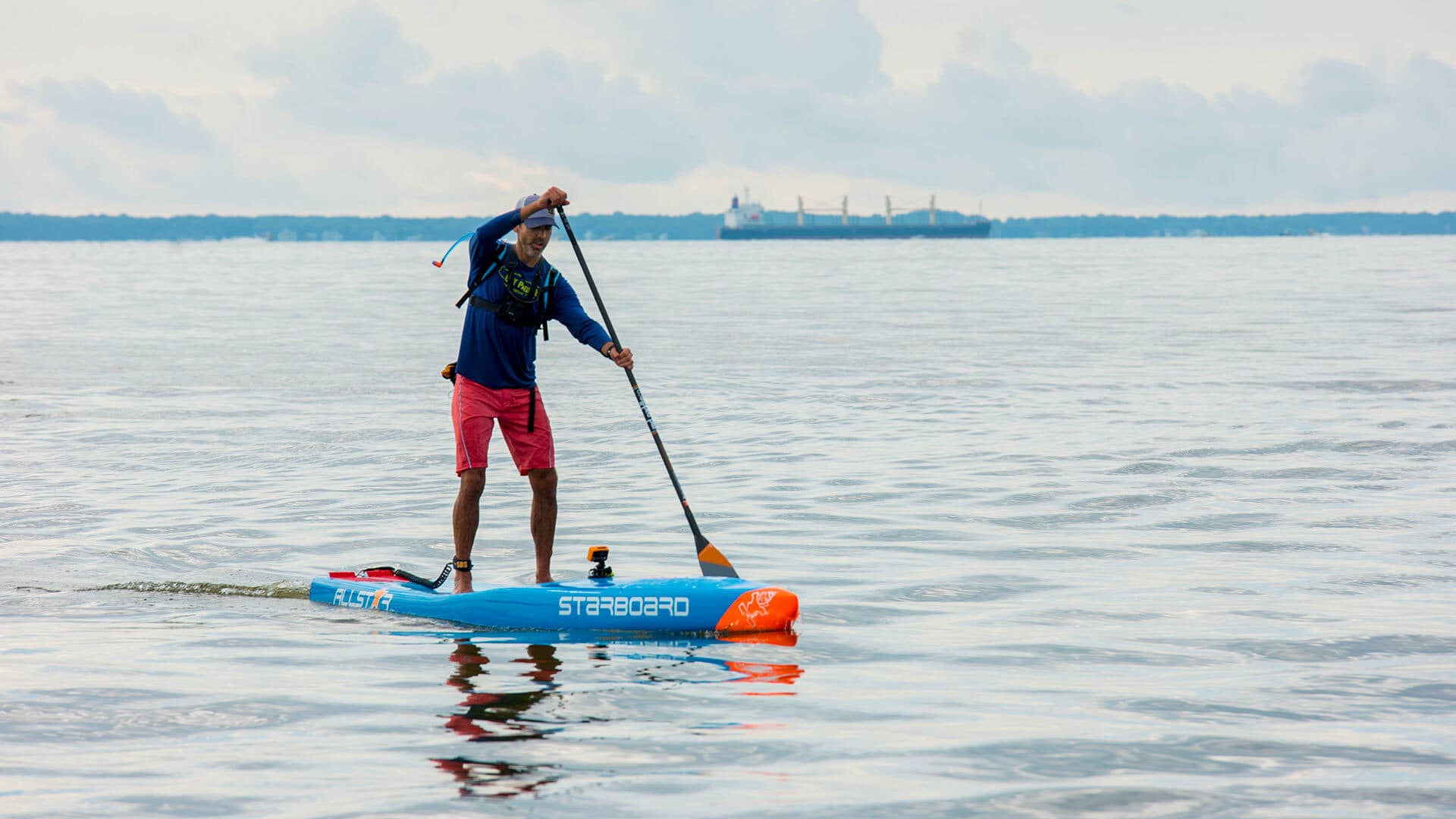 Chris Hopkinson ’96 paddles on a stand-up paddleboard