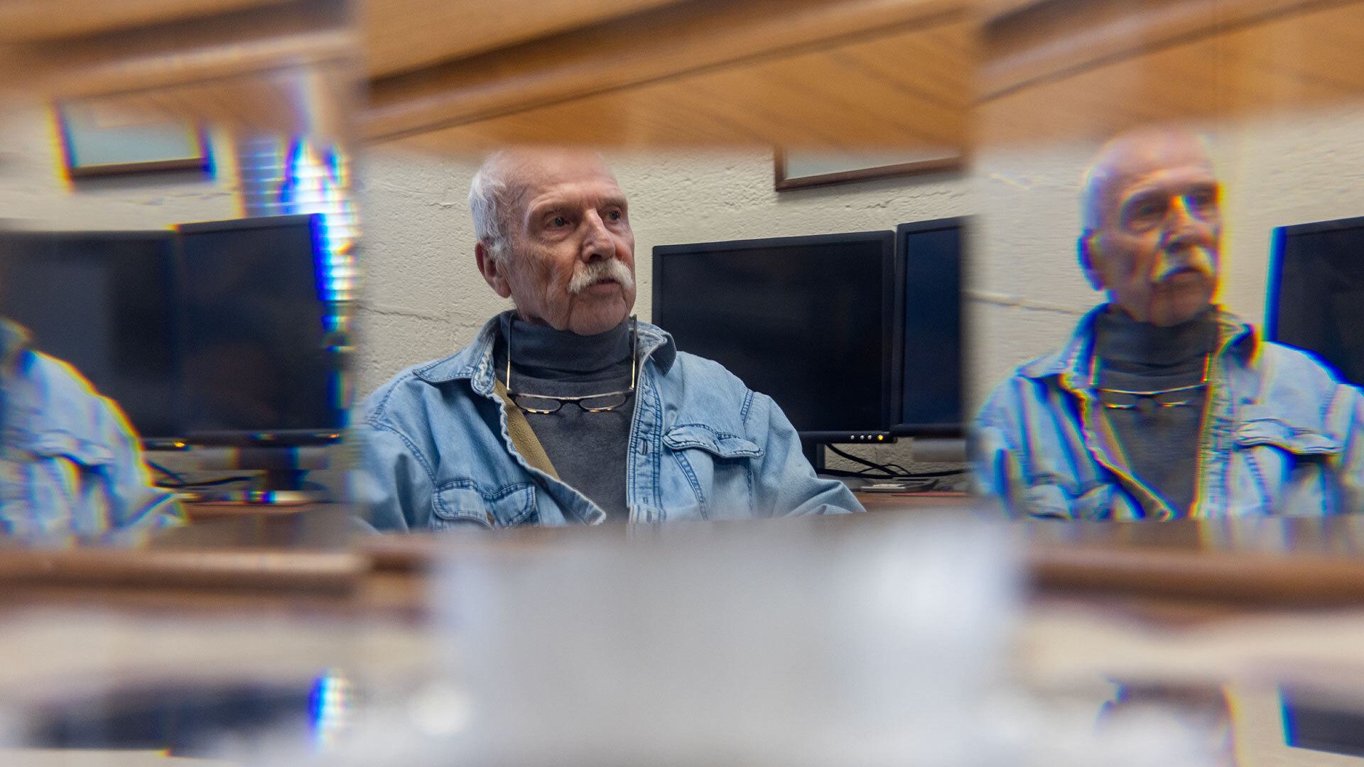 Bill Fourney pictured through plexiglass