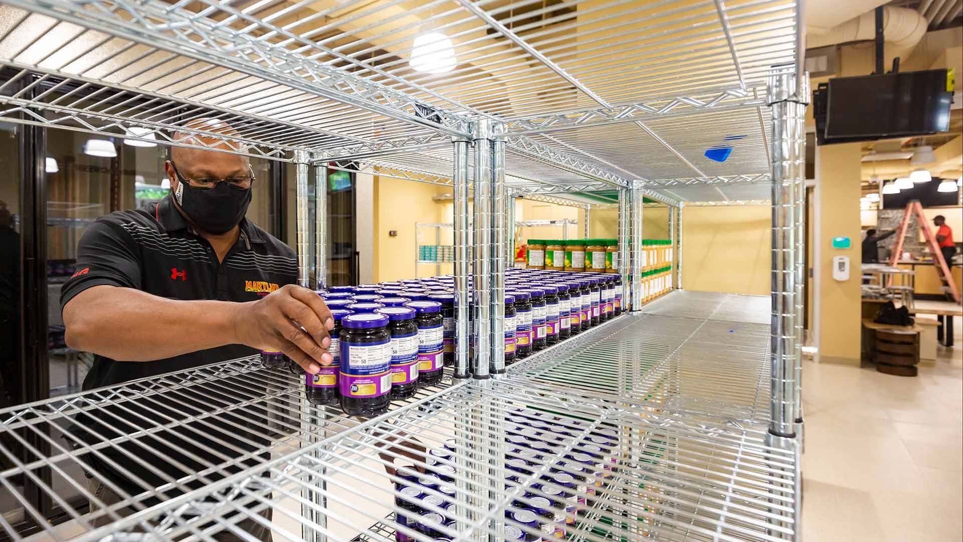 Employee stocks shelves in the Campus Pantry