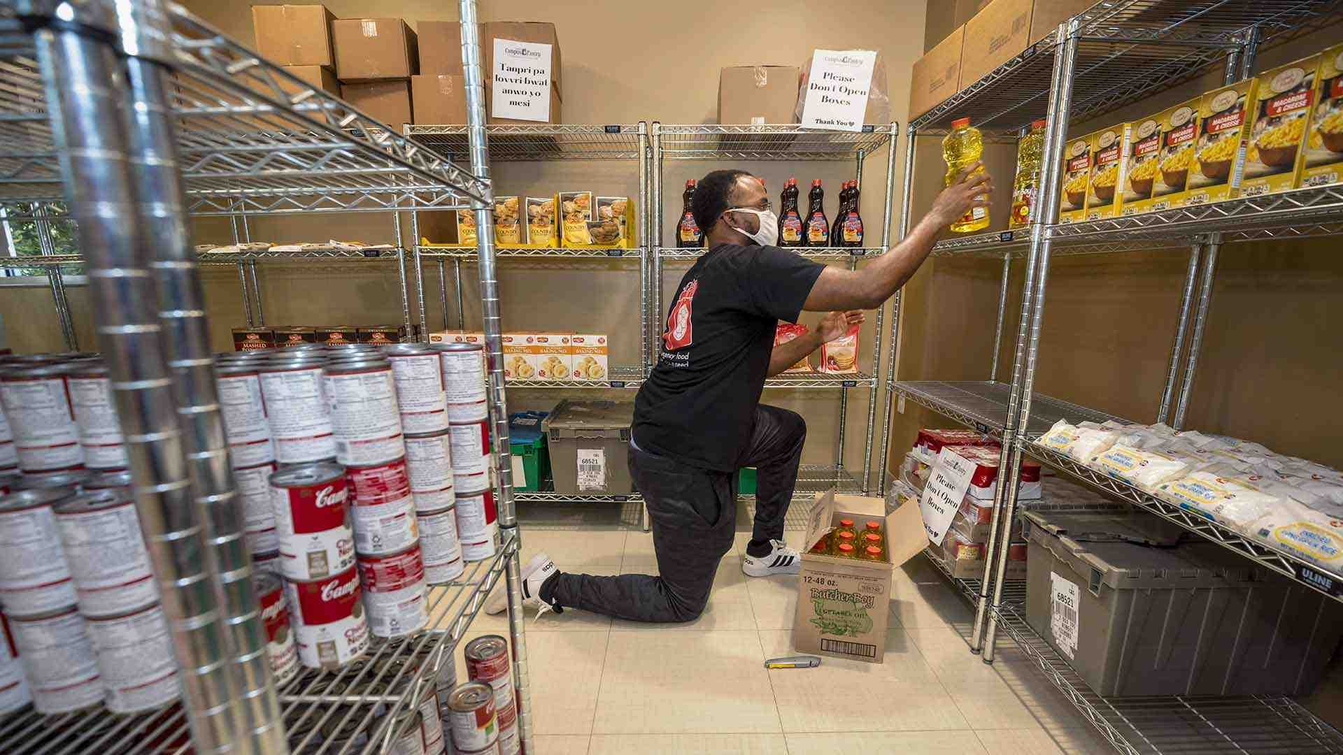 Staff member stocks shelves in Campus Pantry