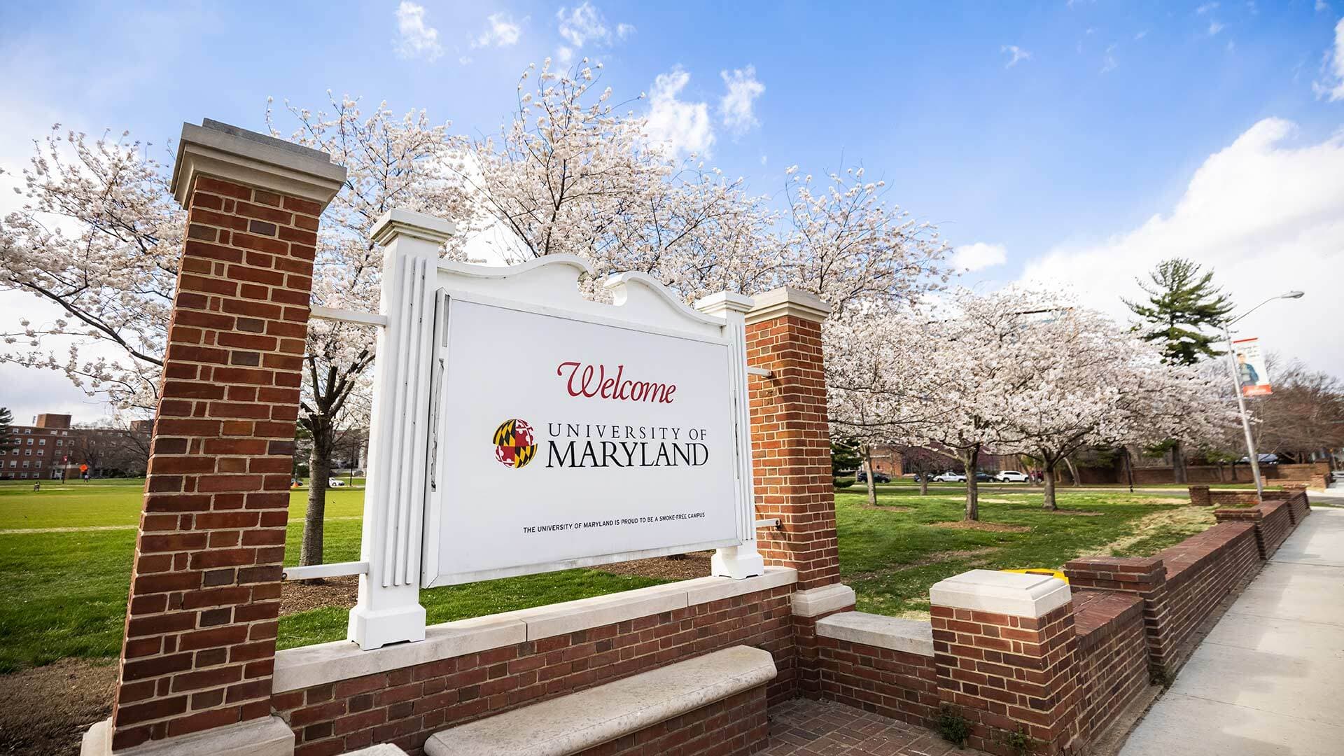 UMD welcome sign with blossoming trees