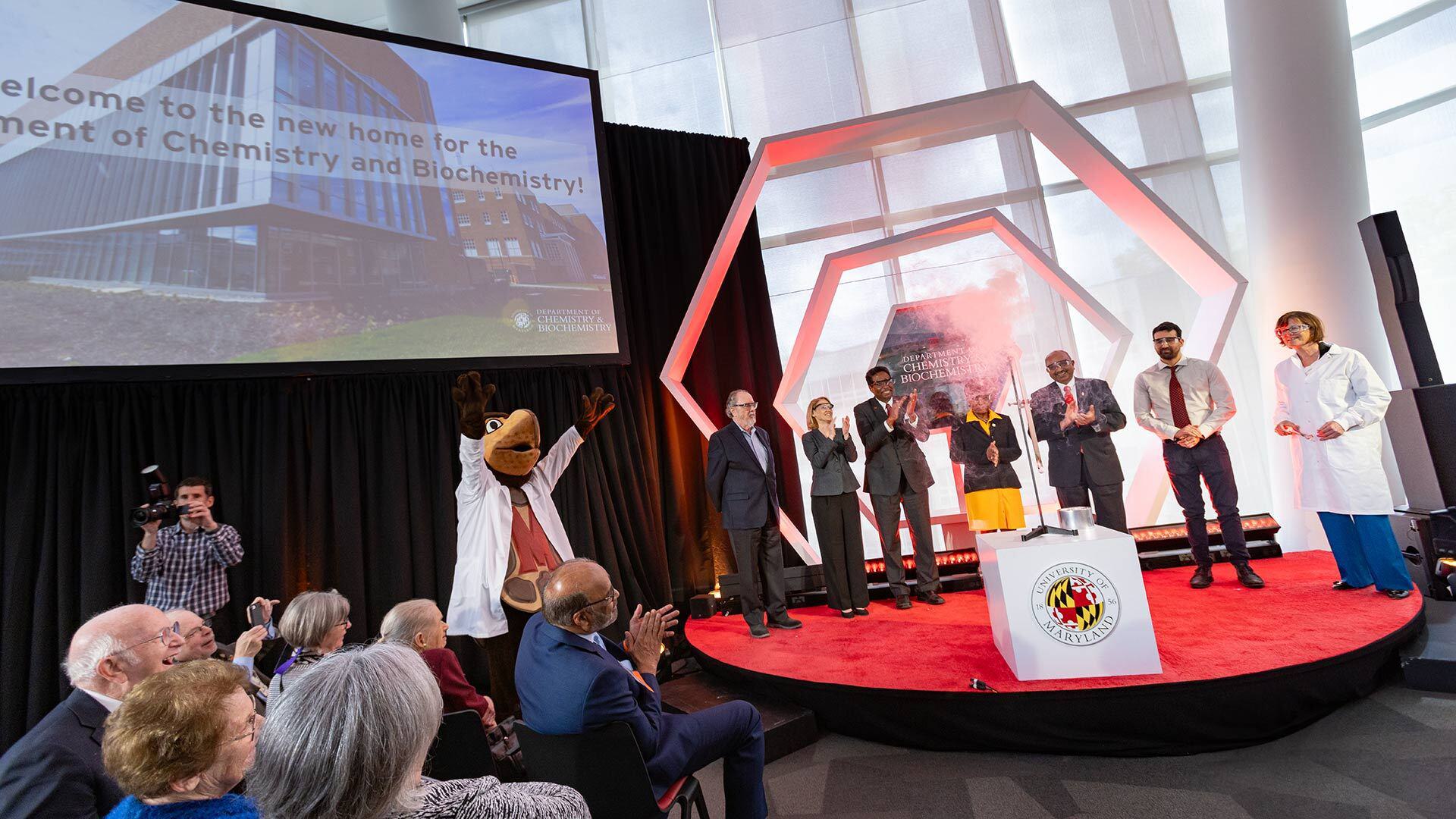 campus leaders clap on stage during Chemistry Building Dedication