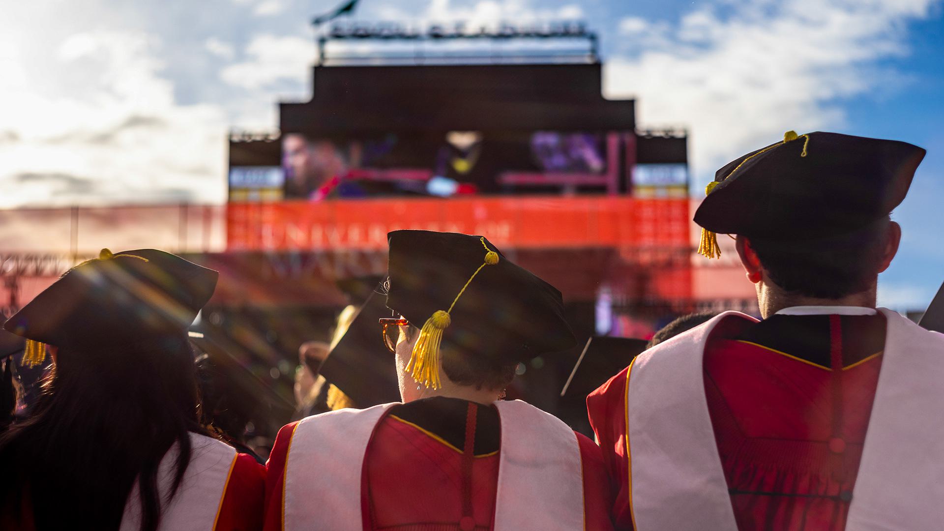 students in doctoral robes at commencement