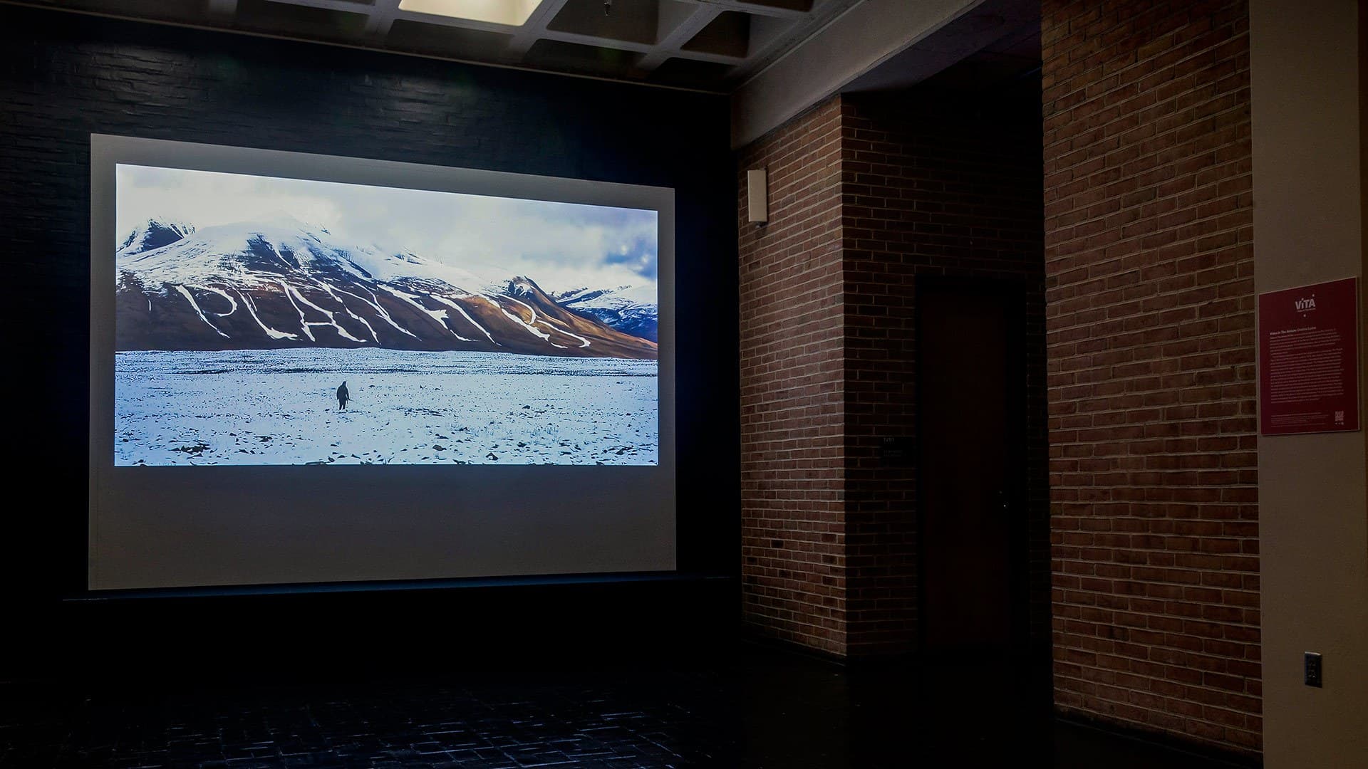 Video of snowy mountains projected on screen