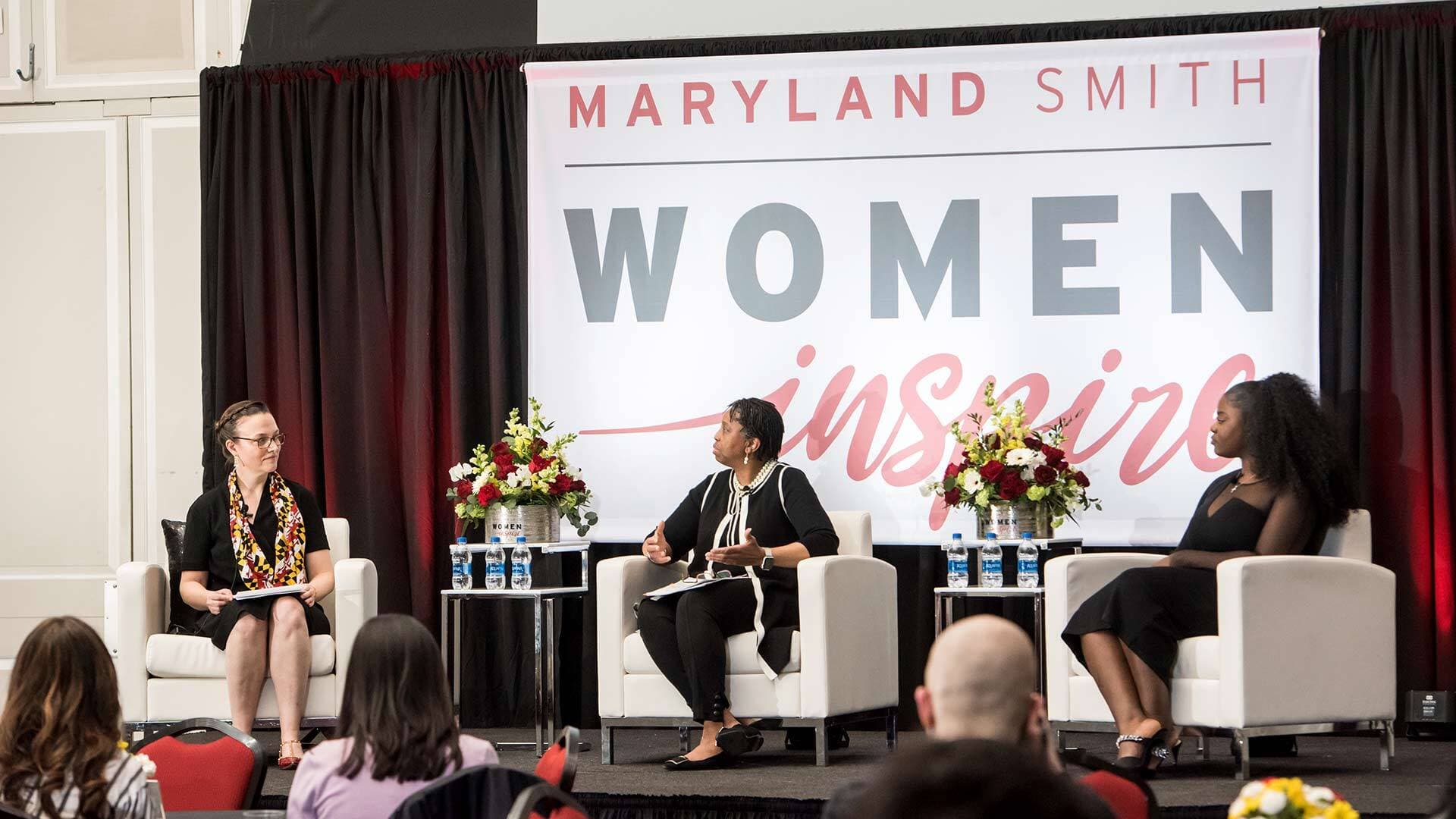Nicole Coomber, Margo Thomas M.S. '90 and L. Audrey Awasom '18 on stage at the Maryland Smith Women Inspire event