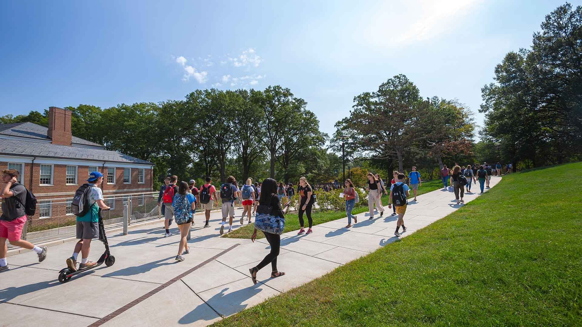 Students walk outside by the Edward St. John building