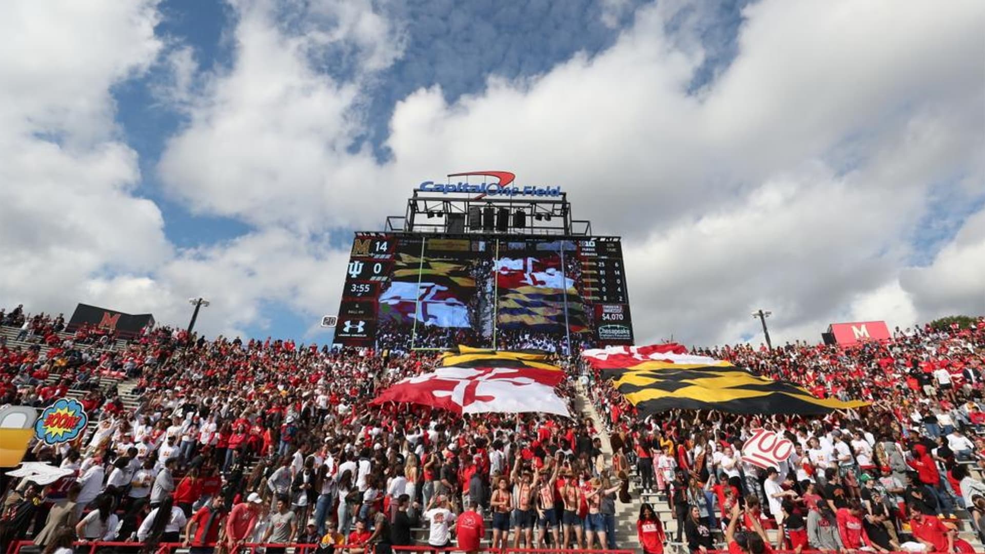 Student section with giant Maryland flag at UMD football game