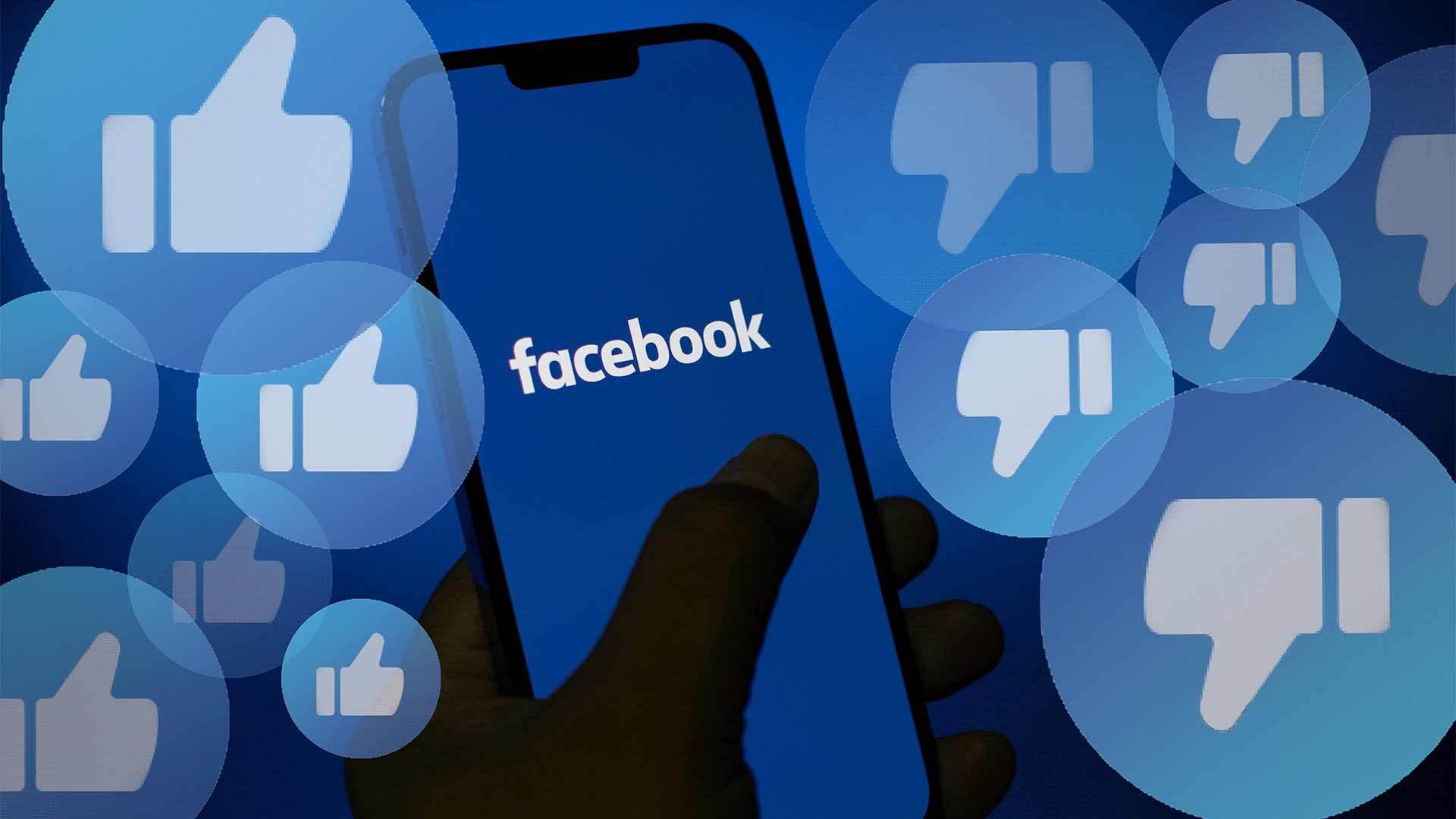 Facebook on smartphone with like and dislike icons