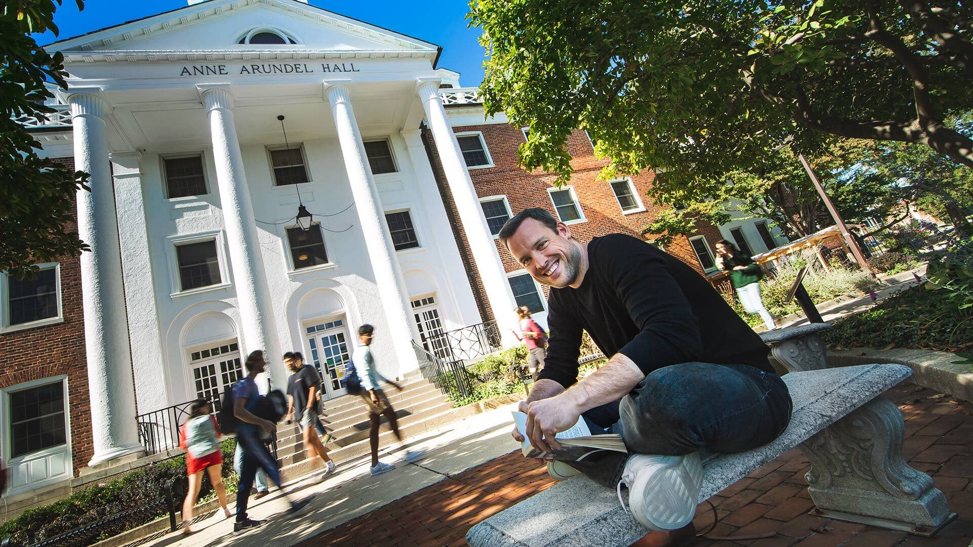 Visiting professor Gero Bauer sits in front of Anne Arundel Hall