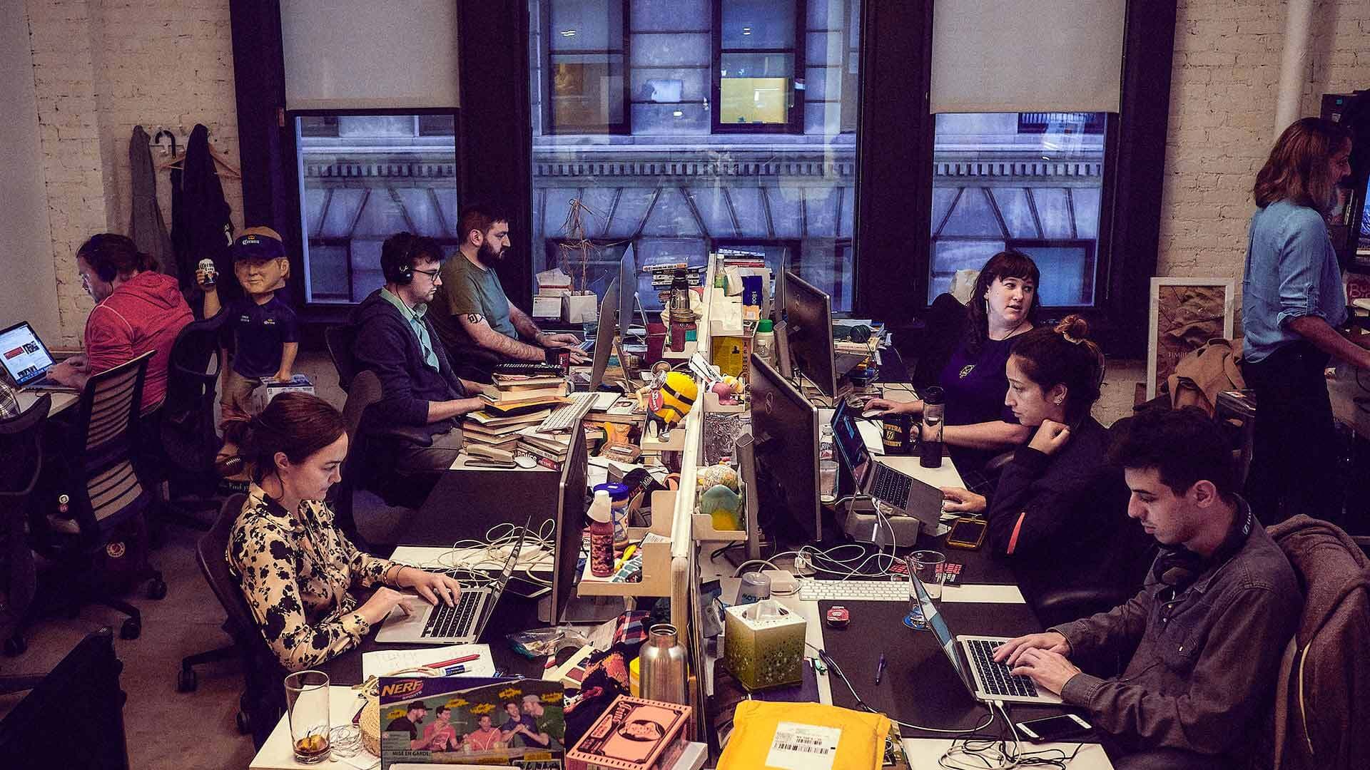 Employees from the website Deadspin work in their New York office last November.
