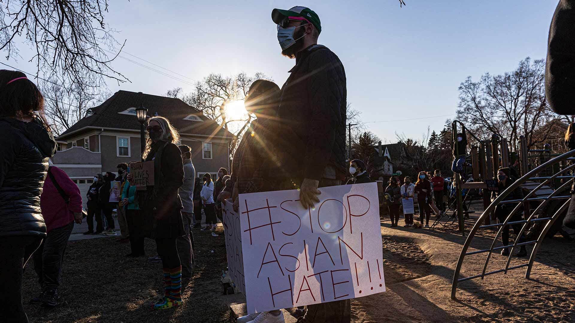 Person holding "Stop Asian Hate" sign