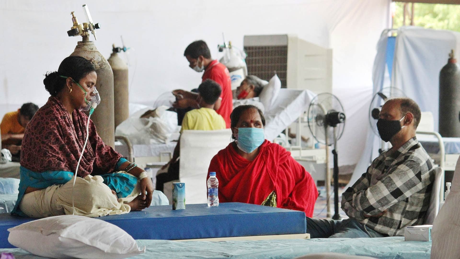 A COVID-19 patient gets oxygen support at a temporary clinic at a banquet hall in New Delhi, India.