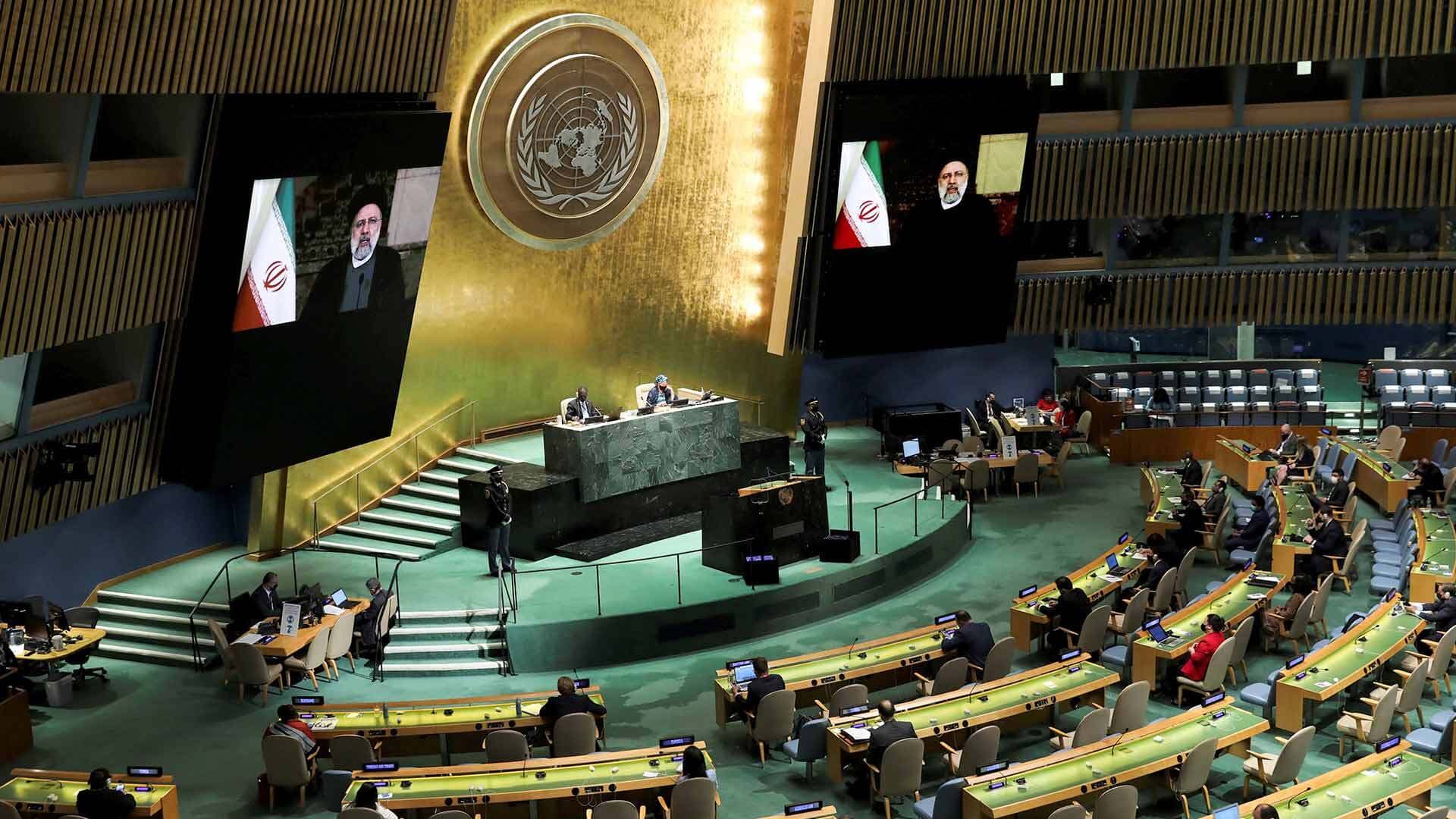 Iranian President Ebrahim Raisi on the screens remotely speaks during the General Debate of the 76th session of the United Nations General Assembly