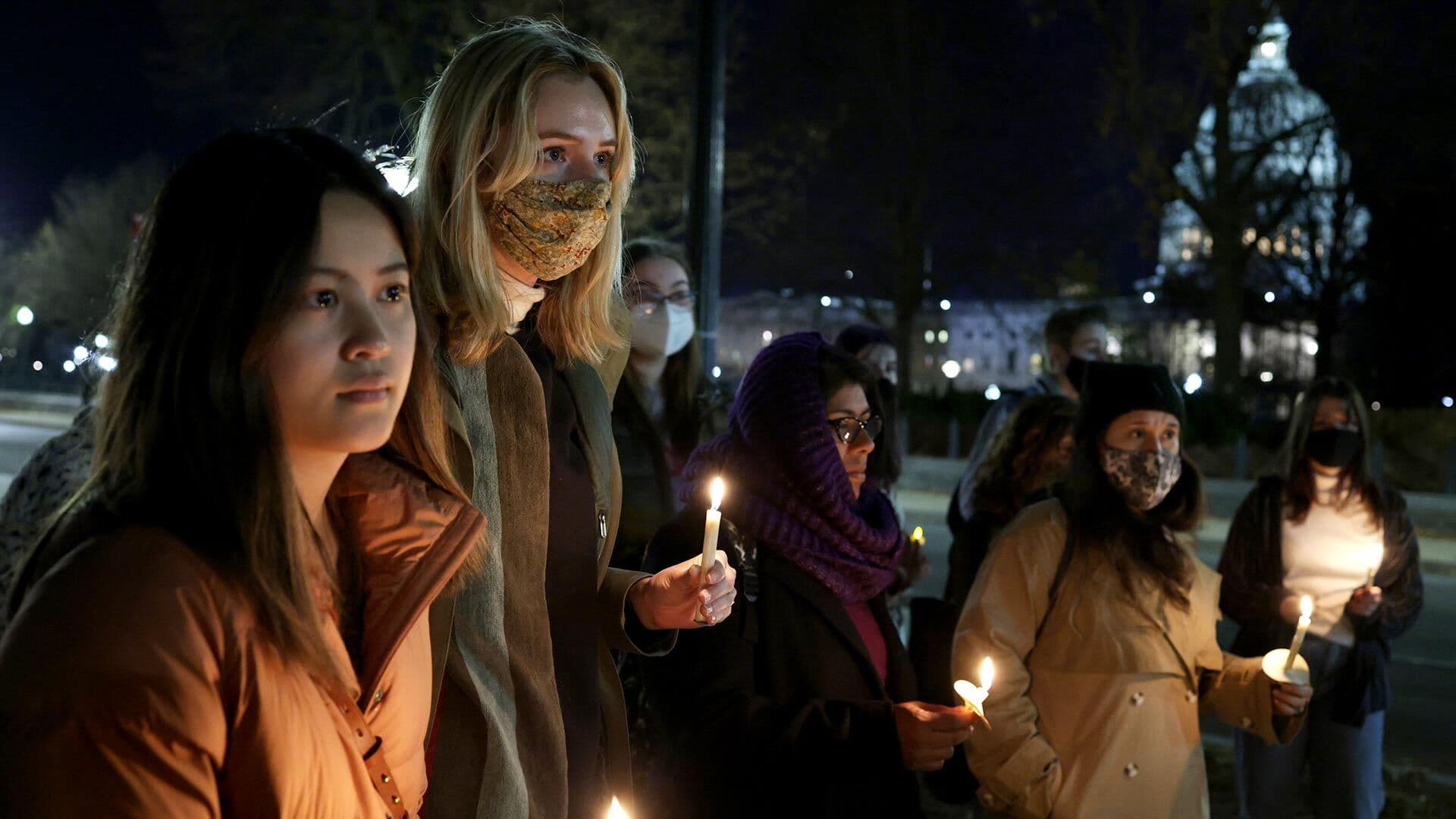 Activists participate in candlelight vigil