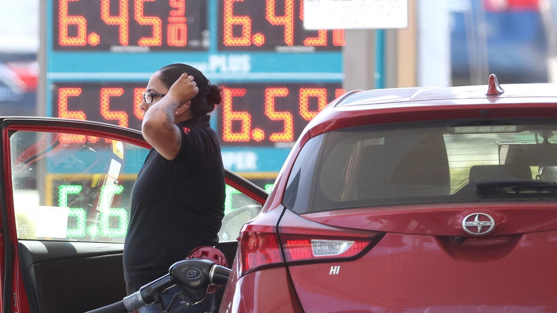 customer pumps gas into car