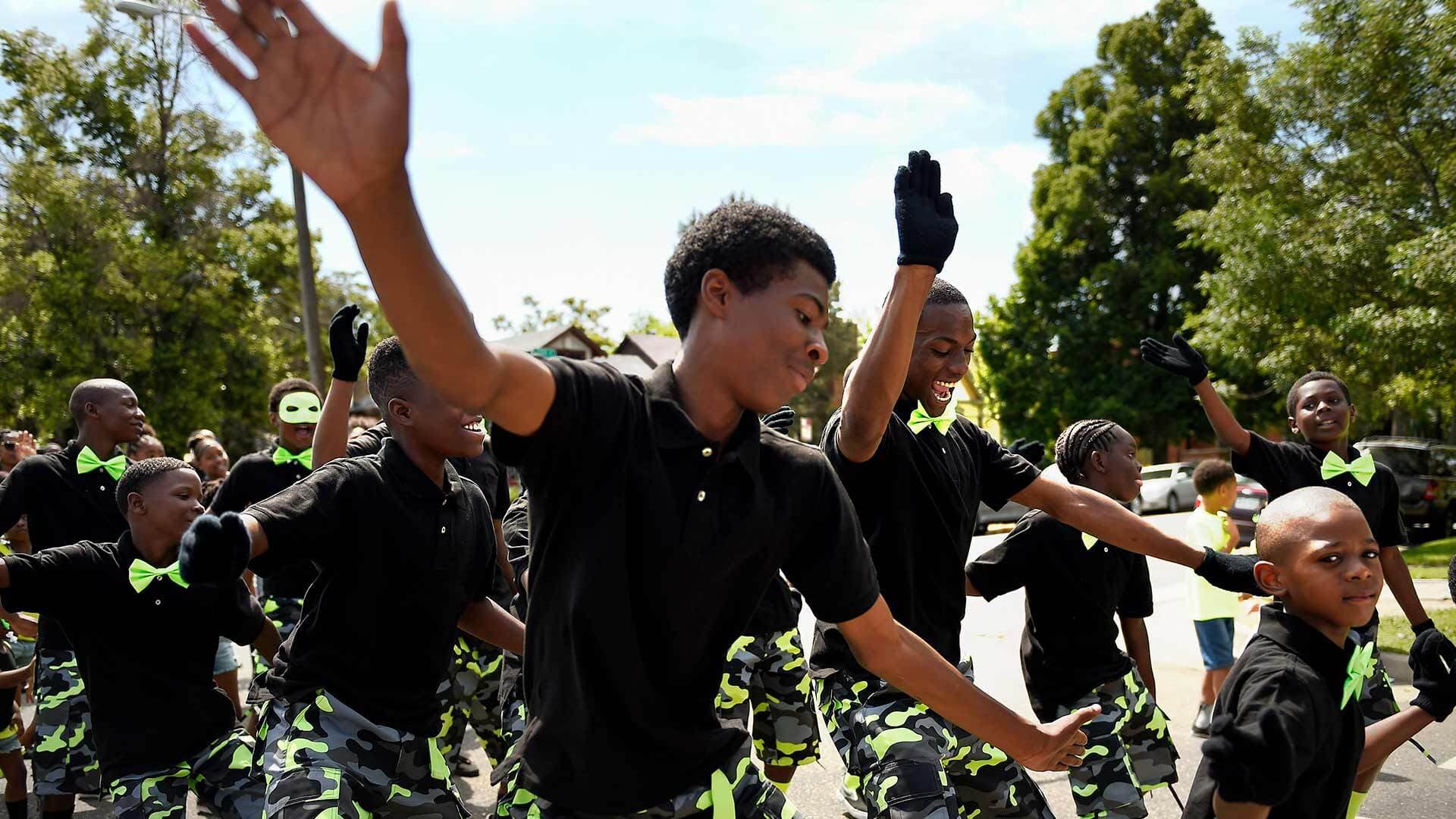Young men dance in Juneteenth celebration parade