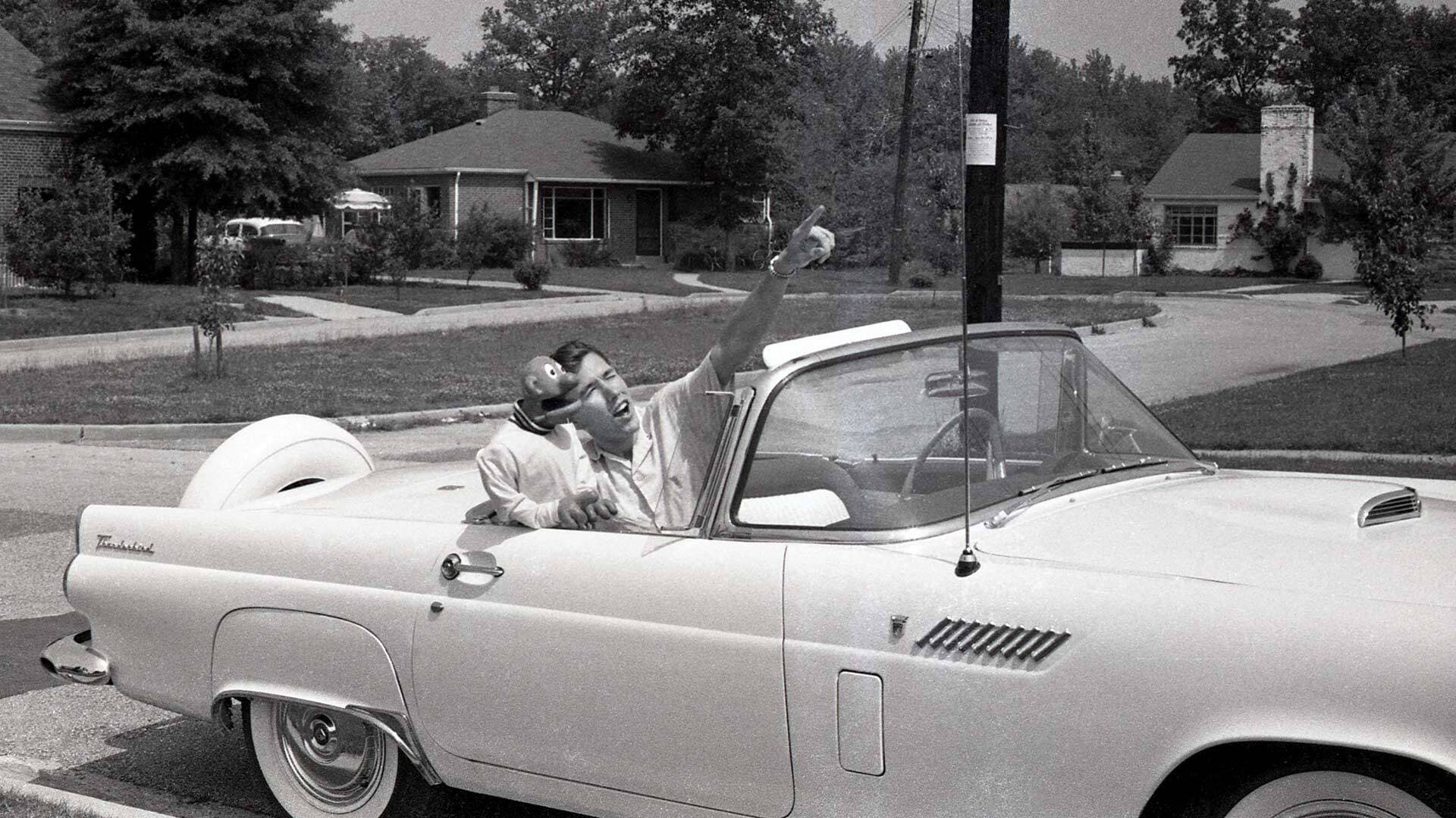 Jim Henson poses with Sam, the star of "Sam and Friends, in a car in front of his parents' University Park home.