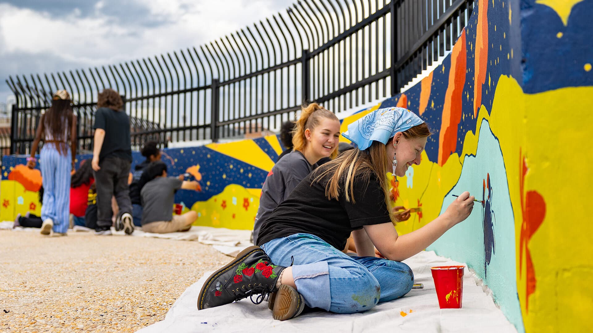students paint mural
