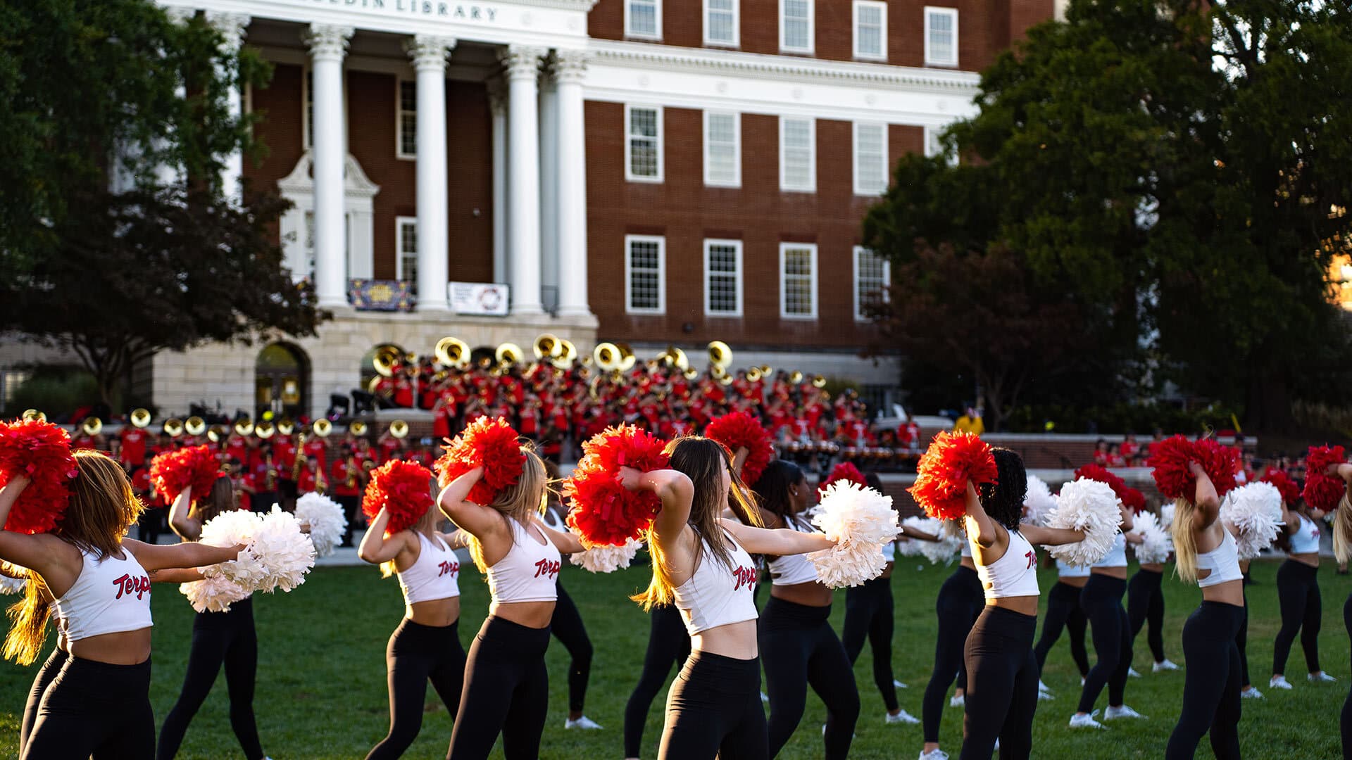 cheerleaders and band perform in front of McKeldin library