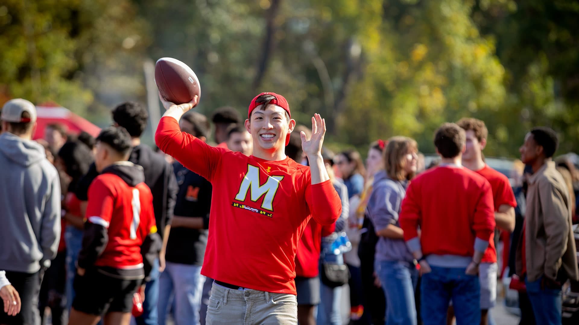 Student throws football at tailgate