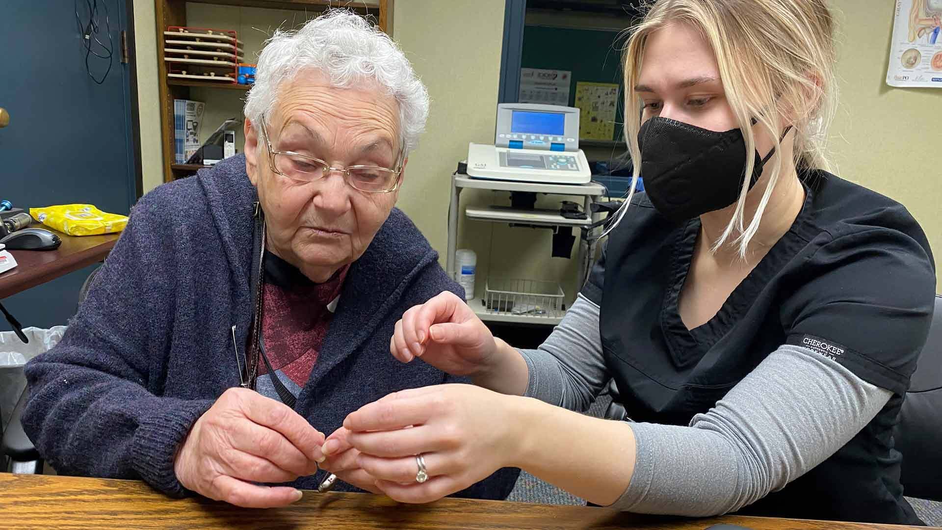 Woman gets fitted with hearing aid