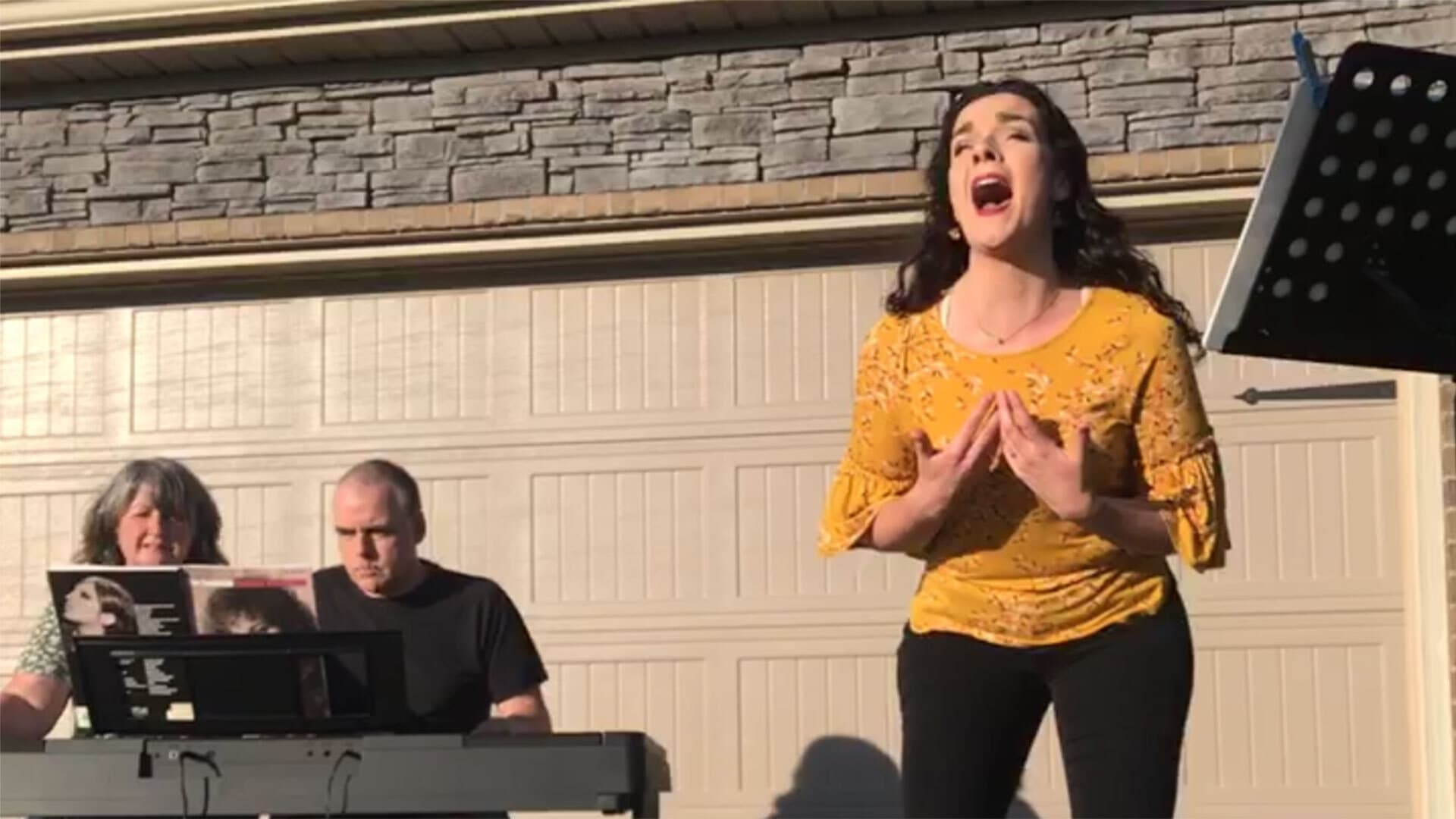 Esther Atkinson sings on driveway