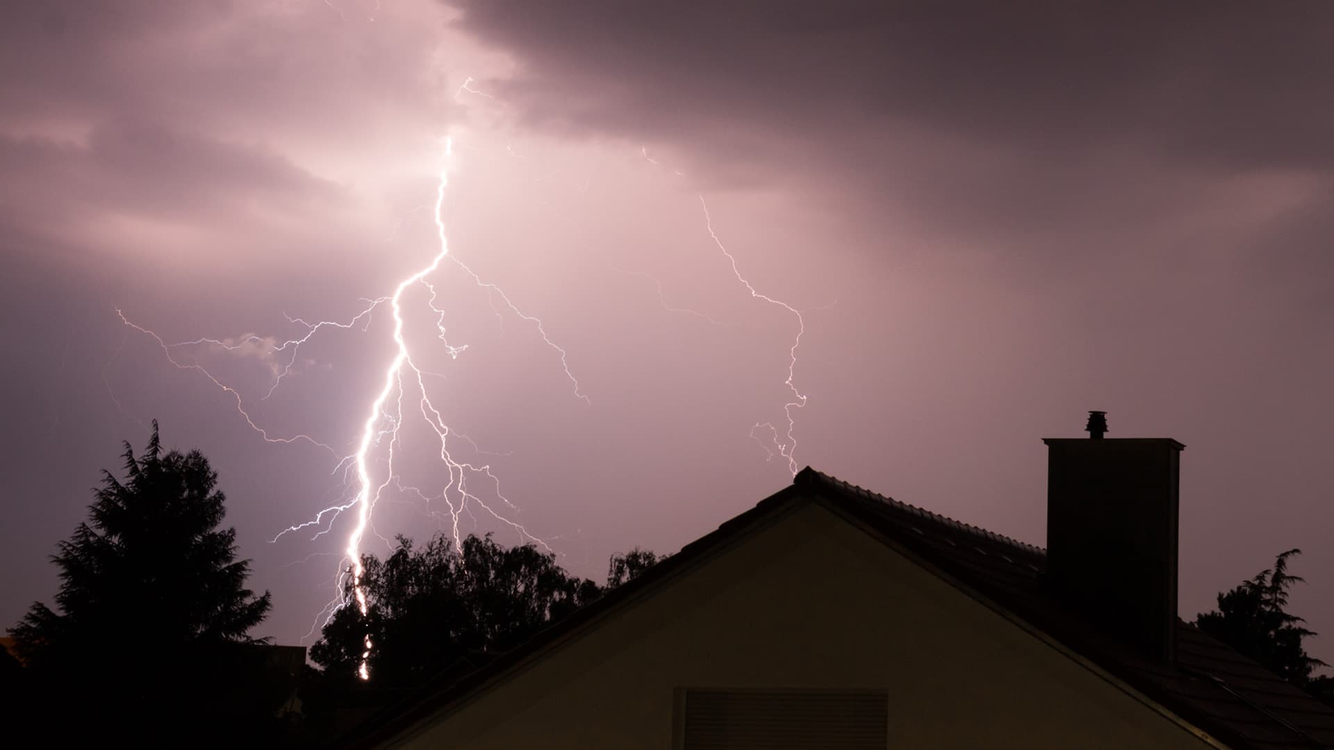 Lightning strikes near a house