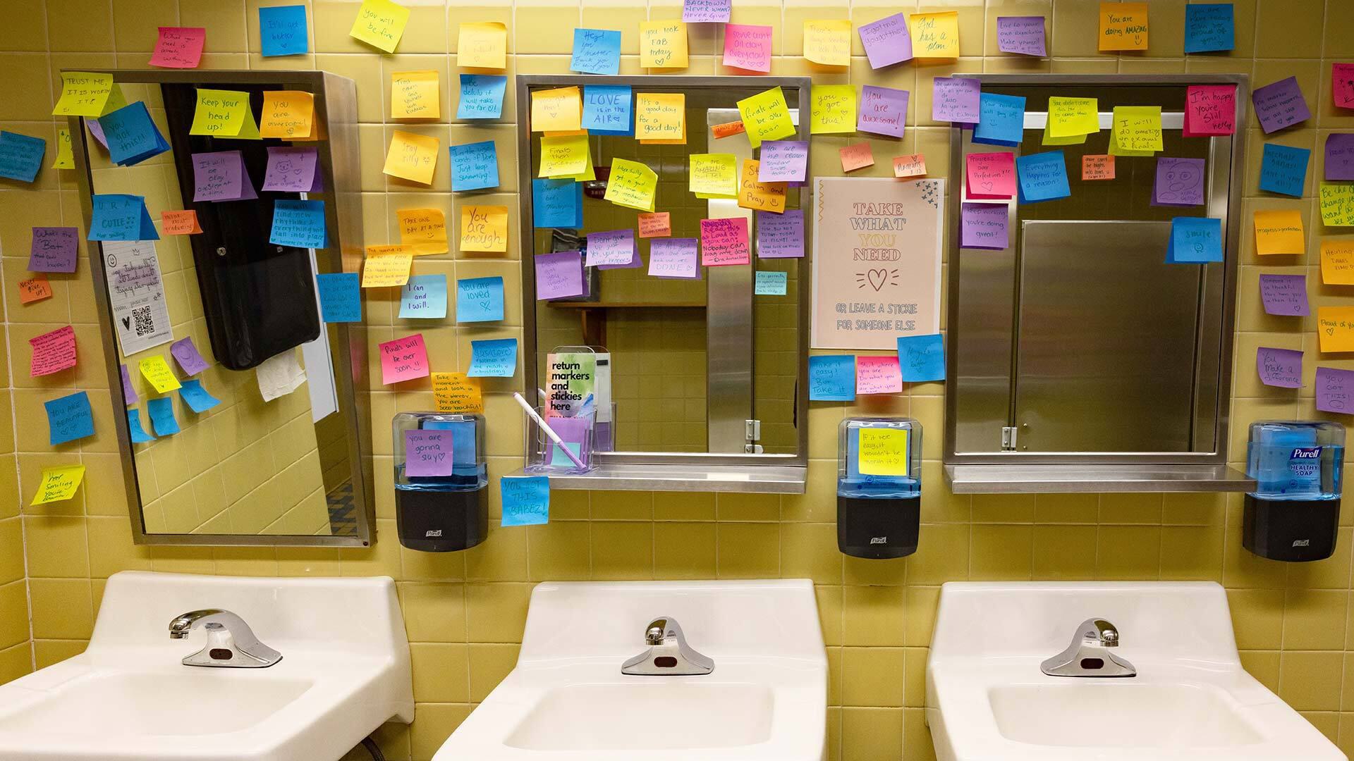 sticky notes on bathroom wall