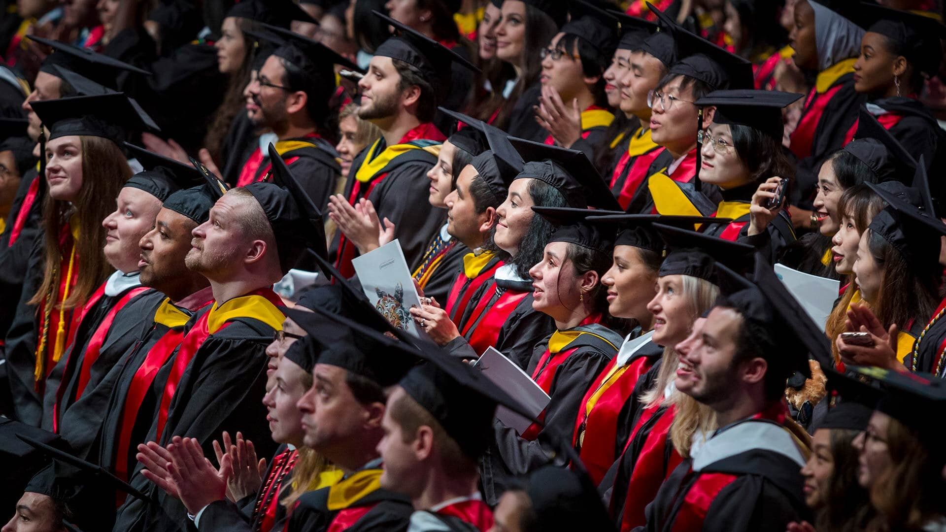 Rows of students in caps and gowns attend the Winter 2019 Commencement ceremony at the Xfinity Center