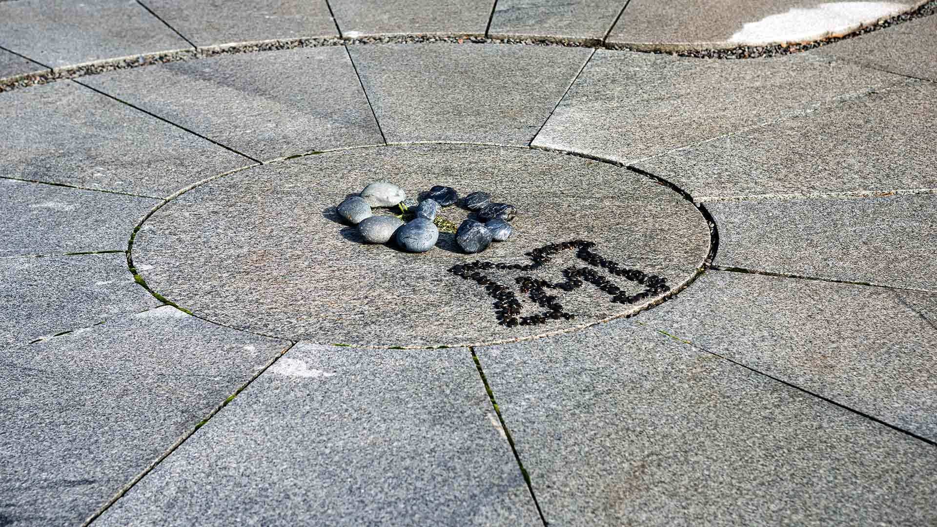 Rocks and a black "M" in the Labyrinth