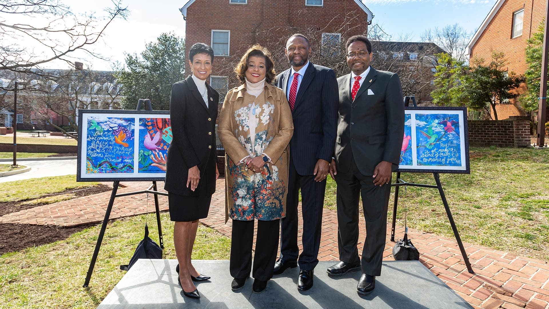 UMD President Darryll J. Pines (right) and Bowie State University President Aminta Breaux (left) stand with Richard and Dawn Collins