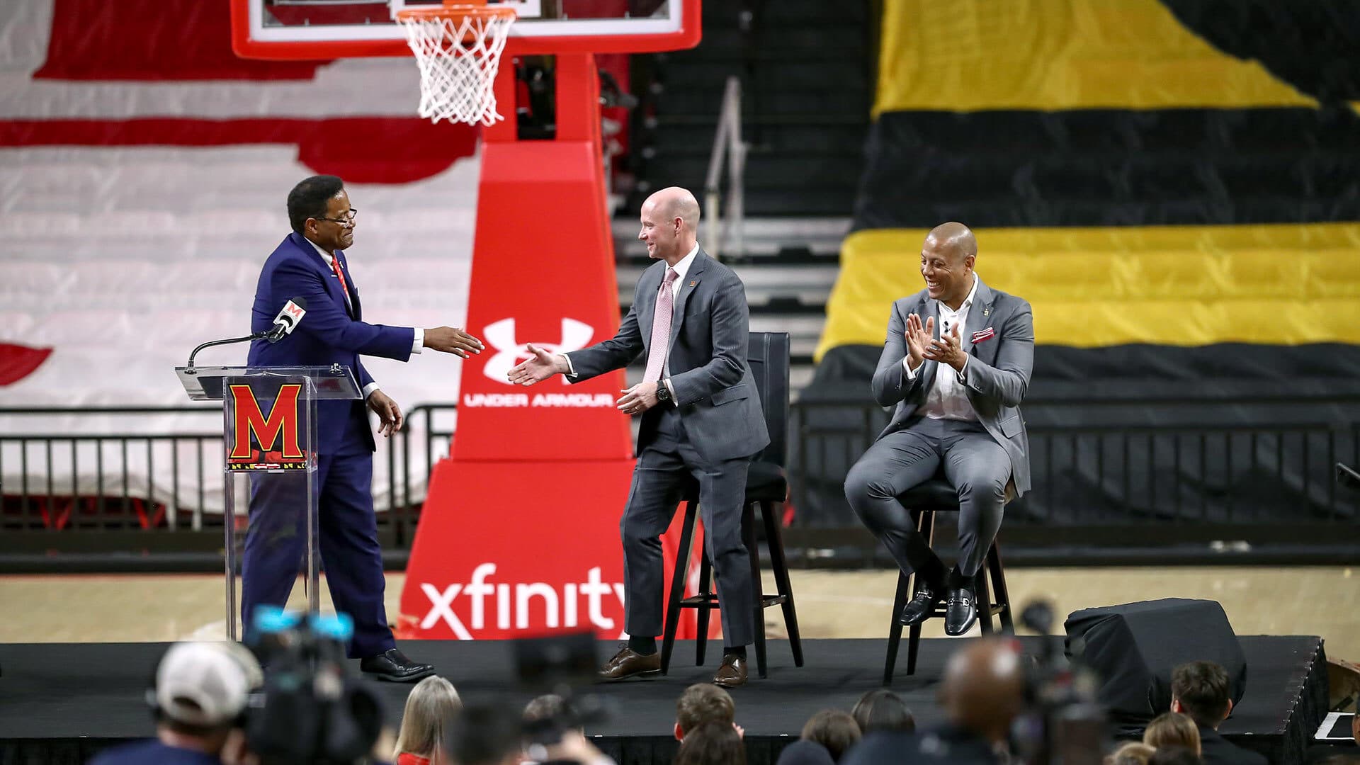 Kevin Willard shakes Darryll J. Pines' hand as Damon Evans claps during press conference