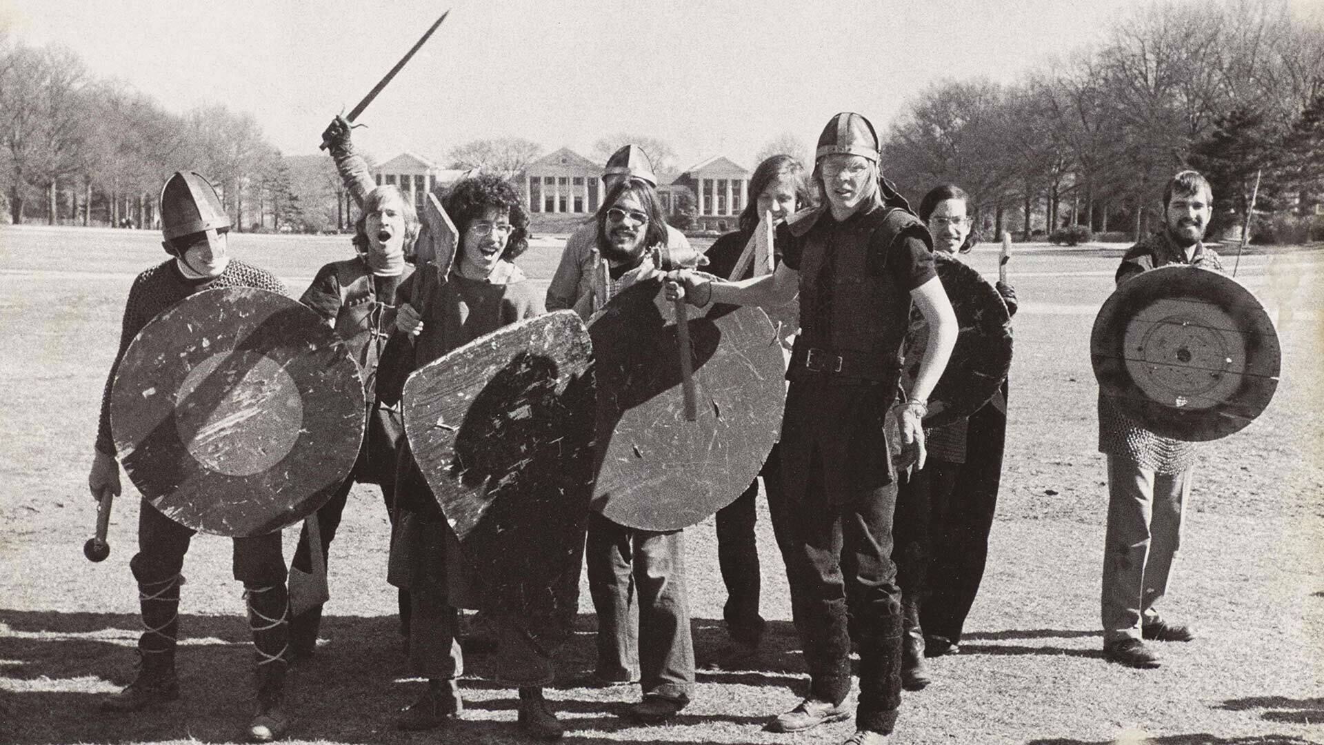 students pose in Medieval costumes on McKeldin Mall