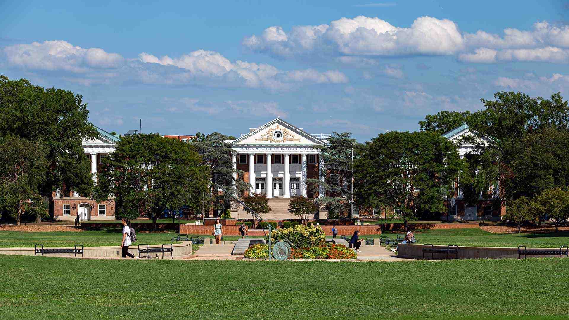 Students walk on McKeldin Mall with the Main Administration Building in the background