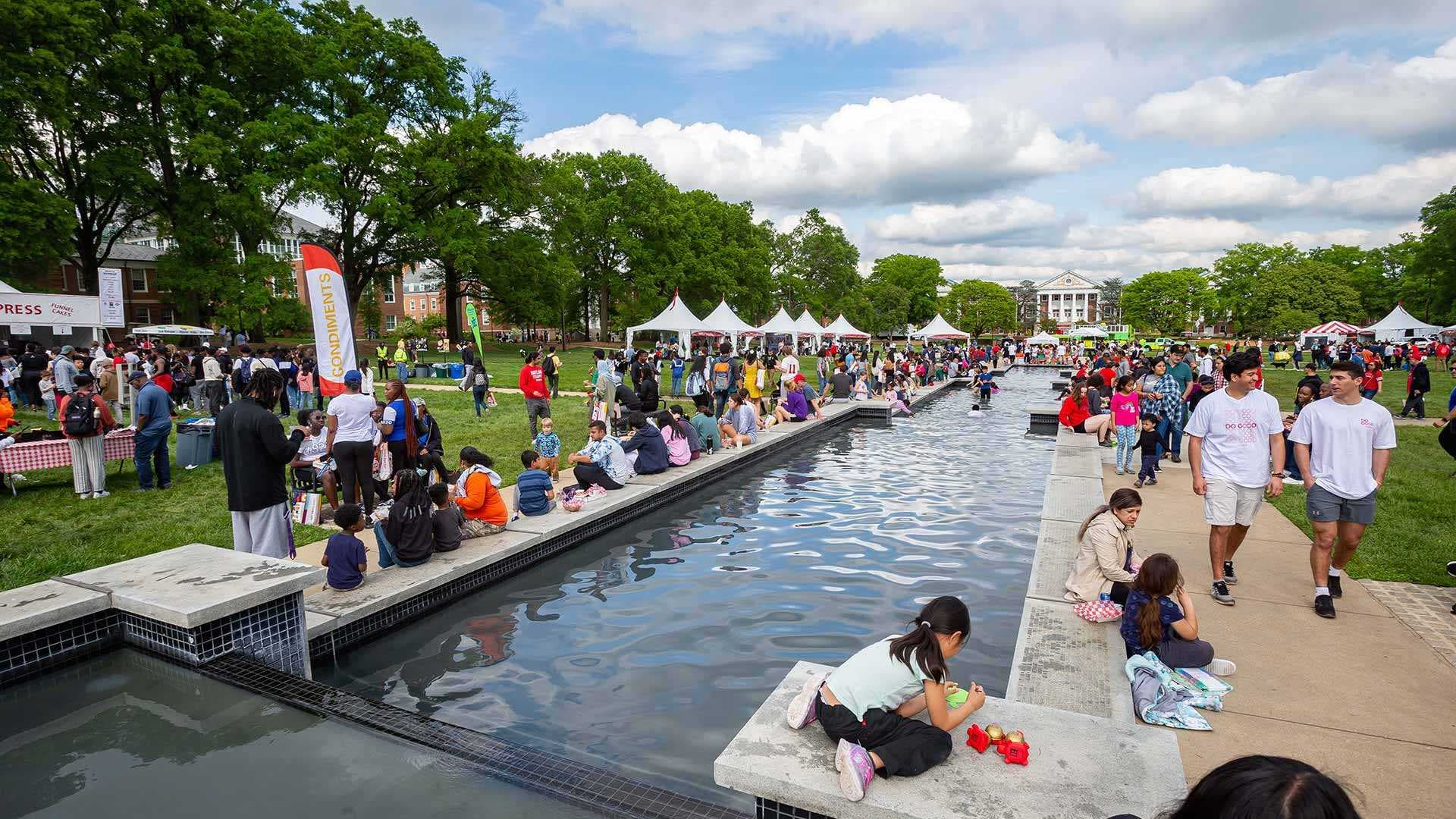 maryland day guests hang around at UMD ODK fountain