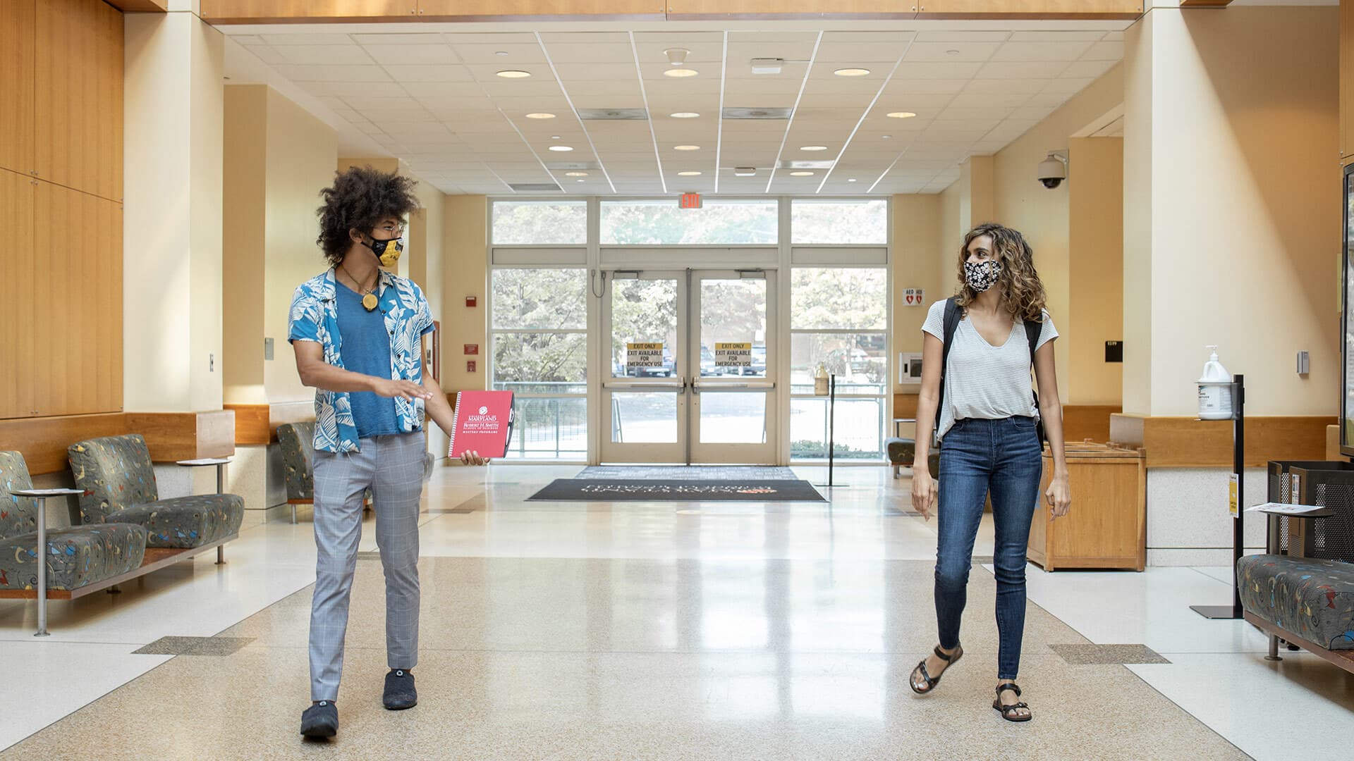Masked students walk through Van Munching Hall