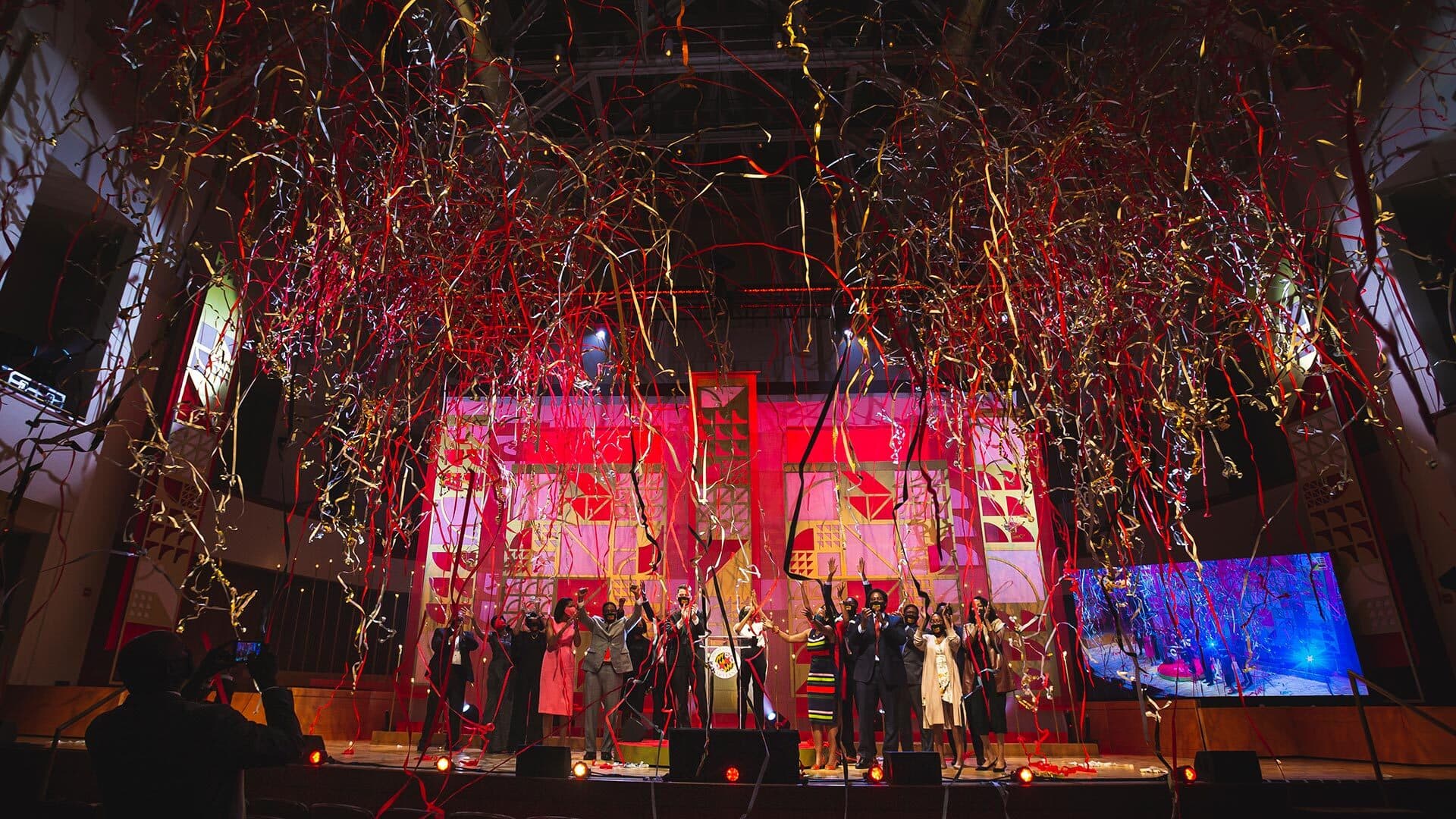 Streamers fall onstage during Moving Maryland Forward event