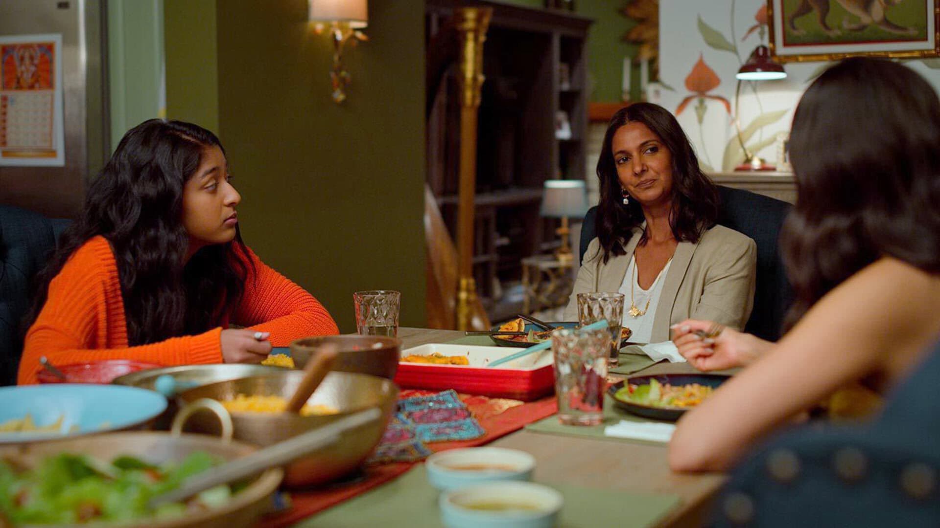 Screengrab of Poorna Jagannathan '96 sitting at the dinner table on Netflix show "Never Have I Ever"