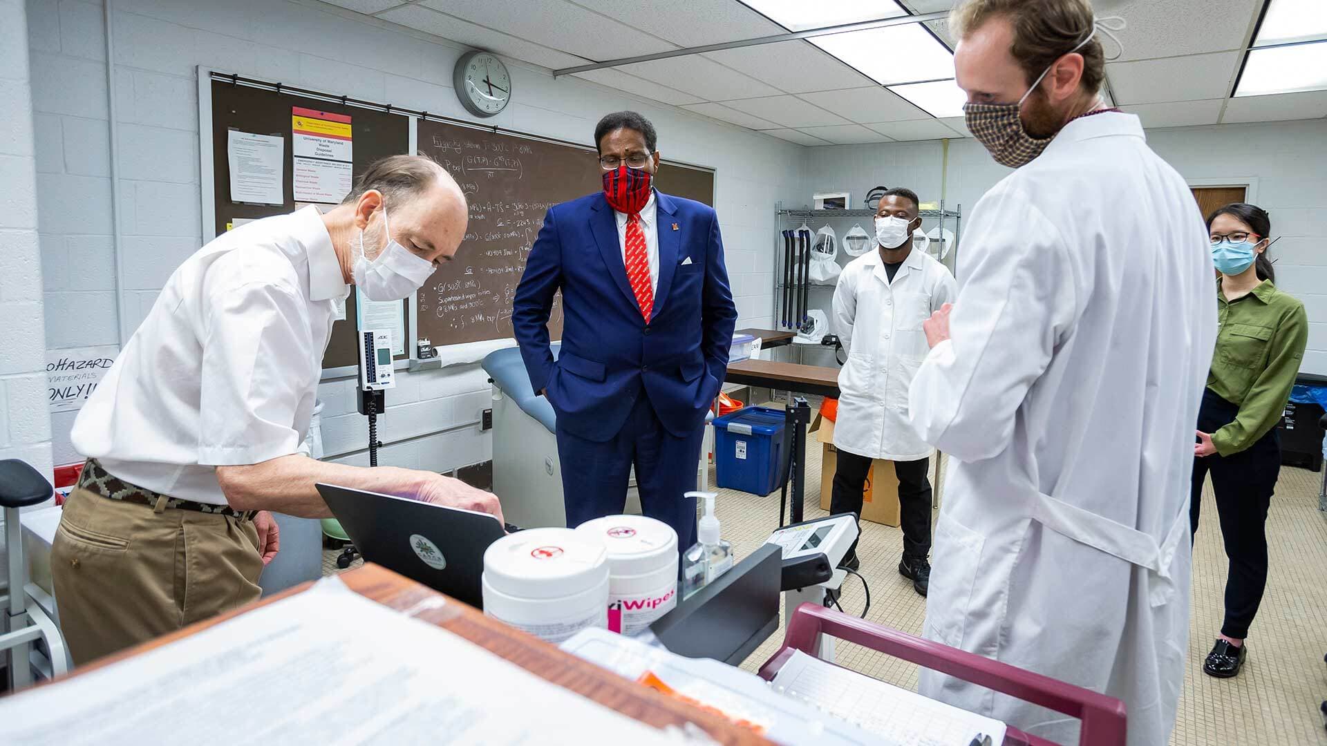 Dr. Don Milton gives President Darryll J. Pines a lab tour