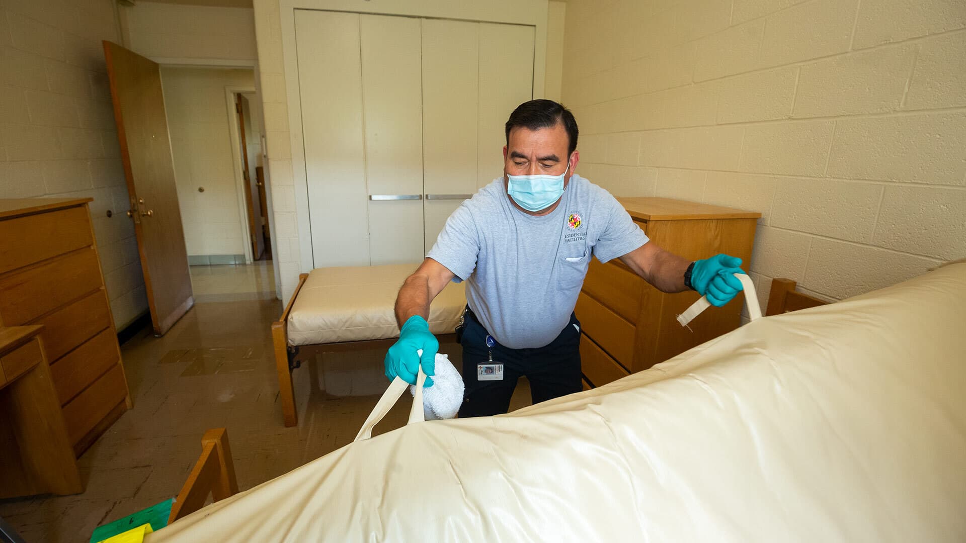 Department of Residential Facilities staff member Pedro Rodriguez cleans a room in Cumberland Hall.