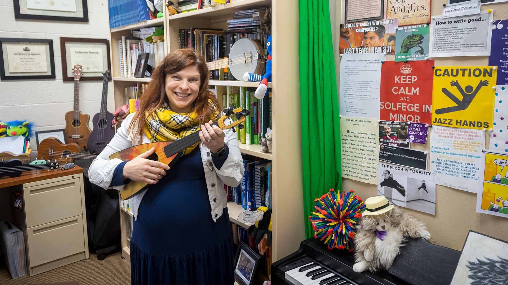 Robin Giebelhausen holds ukulele in her office