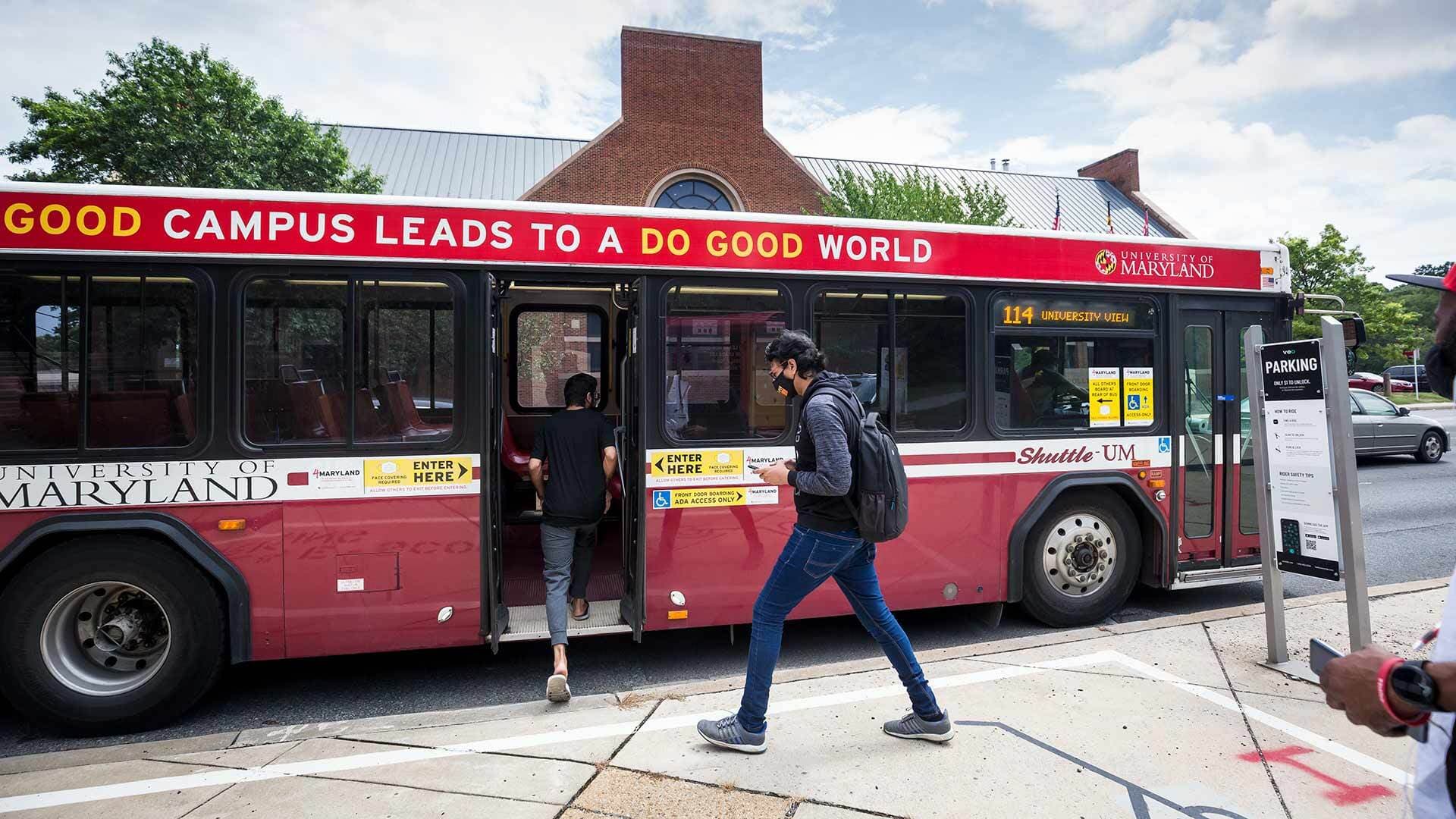 Students board a Shuttle-UM bus